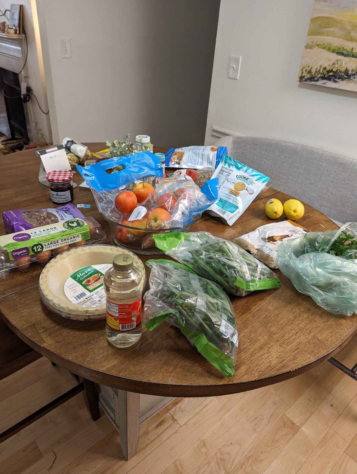 kitchen table laden with a bunch of groceries for pecan pie & green beans