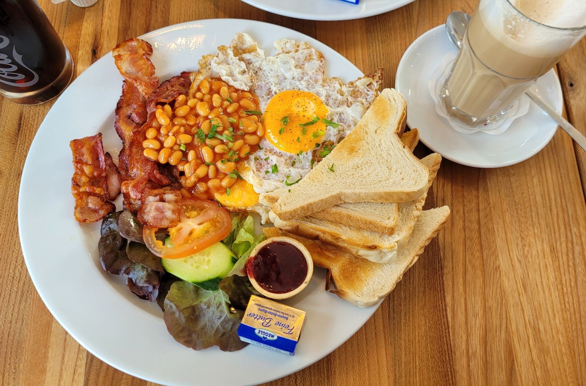 A plate of Full English Breakfast without hash browns but with jam instead. 