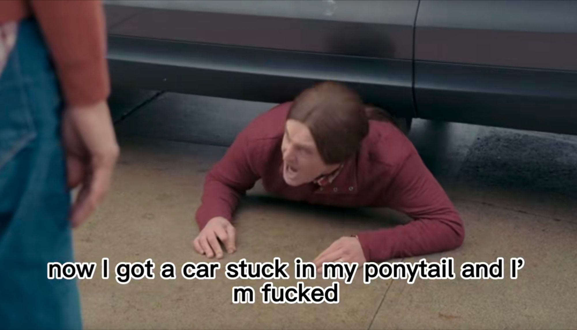 Will Forte's character (still stuck between the car and the sidewalk) screams "now I got a car stuck in my ponytail and I'm fucked!"