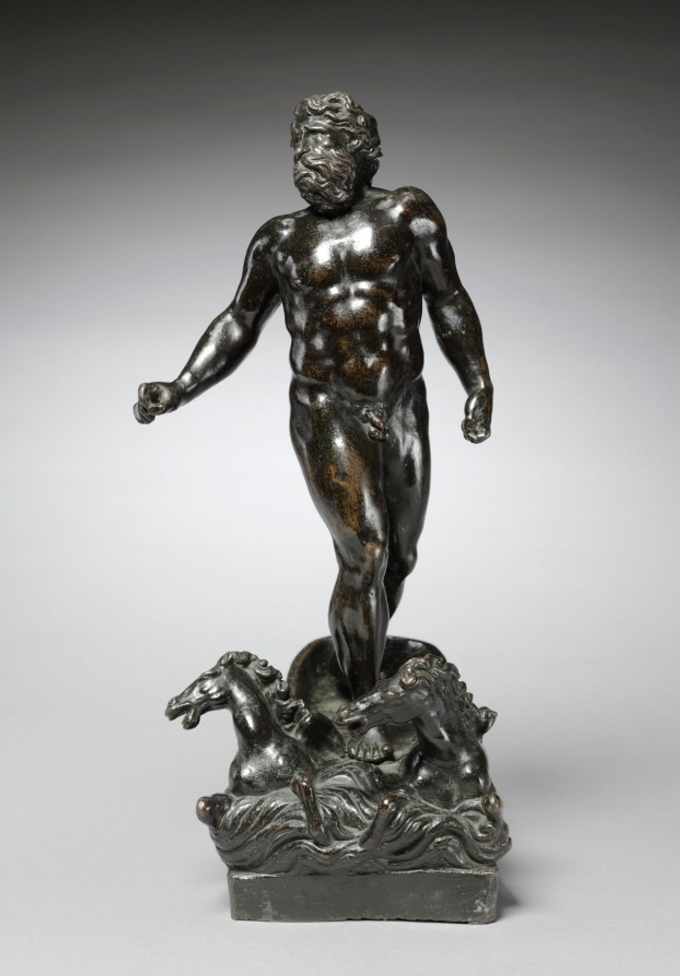 In Roman mythology, Neptune (or Poseidon in Greek mythology) is the god of flowing water and is believed to protect against droughts. This small bronze is likely a sculptural representation of the Wrath of Neptune from the Aeneid. During the Trojan War, Juno incited winds to sink Trojan ships. Infuriated by Juno's incursion into his domain of the sea, Neptune rides out in his chariot, saving the Trojan army and threatening to punish the winds for their insolence. The massive, muscular nude male figure stands upright on his seahorse-drawn chariot, twisting to face the wind. The turbulent waves and the windblown hair and beard of the figure give life to this small bronze. The figure's left hand would have originally held reins, while the right hand, which once held a trident, is outstretched in the act of commanding the waves to be still. This bronze was once attributed by art historian Wilhelm von Bode to Jacopo Sansovino based on its similarity to known works, such as the over-life-size marble figure of Neptune of the Scala di Giganti outside of the Doge's Palace in Venice. However, by 1921 Leo Planiscig had noted the CMA Neptune's similarity to bronzes and reliefs by Sansovino's pupil, Tiziano Minio, in the Loggetta at San Marco Square, Venice. In Minio's Jupiter on the Island of Candia for the Loggetta, the waves are represented with the same incised, undulating grooves as in this work. Neptune possesses the same stocky proportions and heavy musculature which was characteristic of Minio. The high polish and sweeping contours of the figure are characteristic of Sansovino, but the heightened drama of the subject display Minio's stylistic advancement from his teacher.