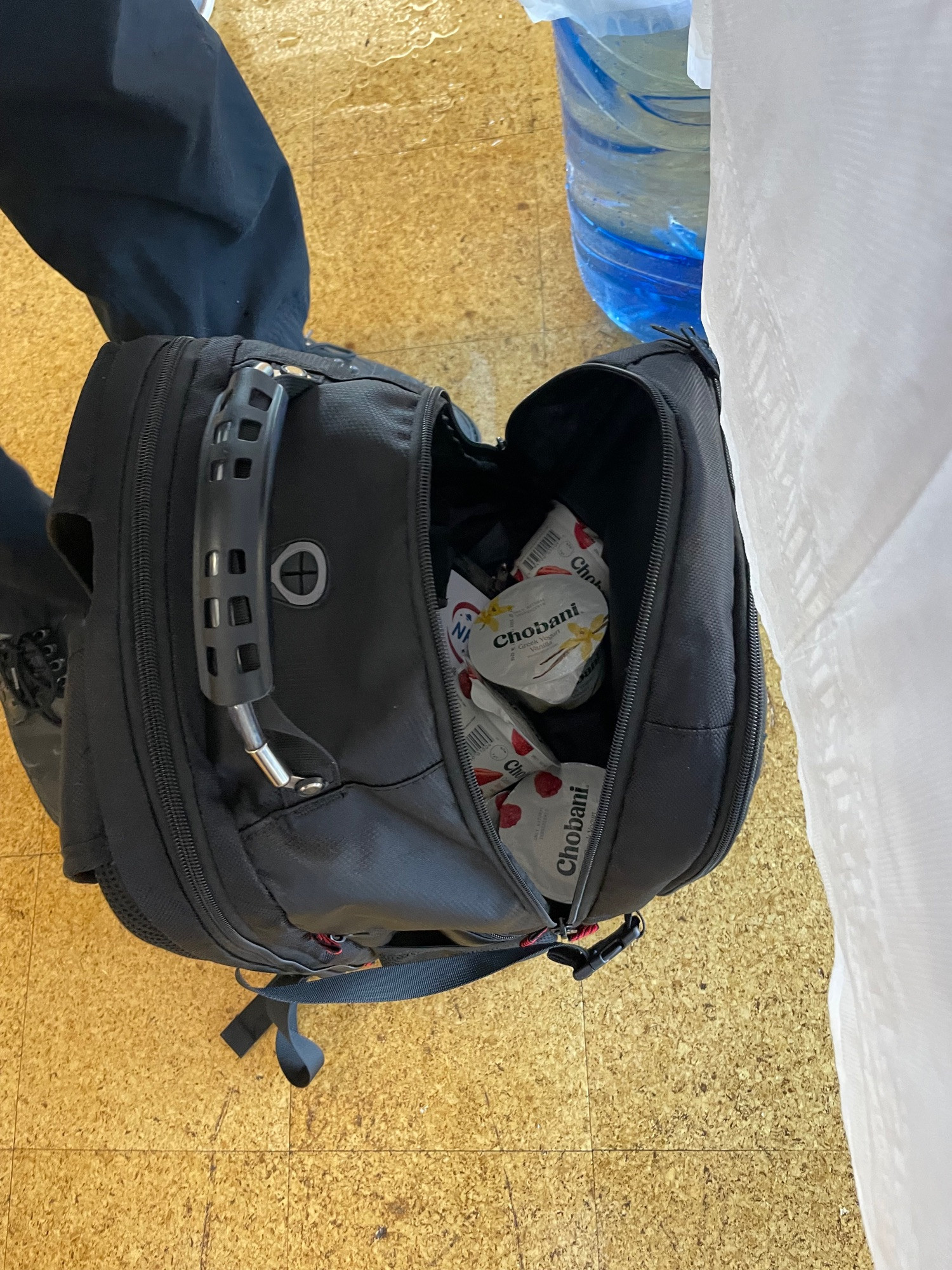 Backpack full of chobani yogurt cups that were leftover from a conference breakfast