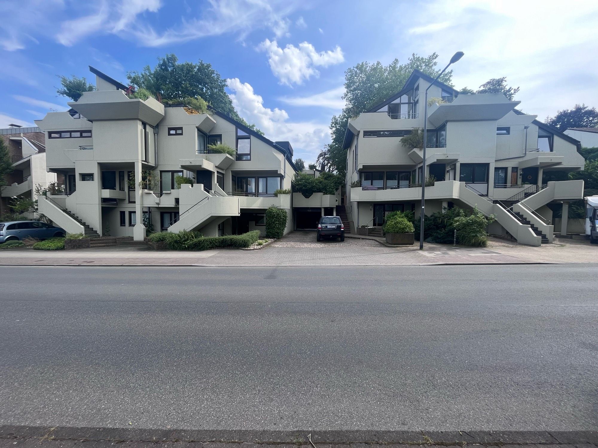 A blocky, angular condo complex around a central driveway