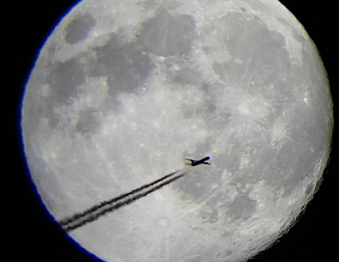 Plane flying right in front of the moon