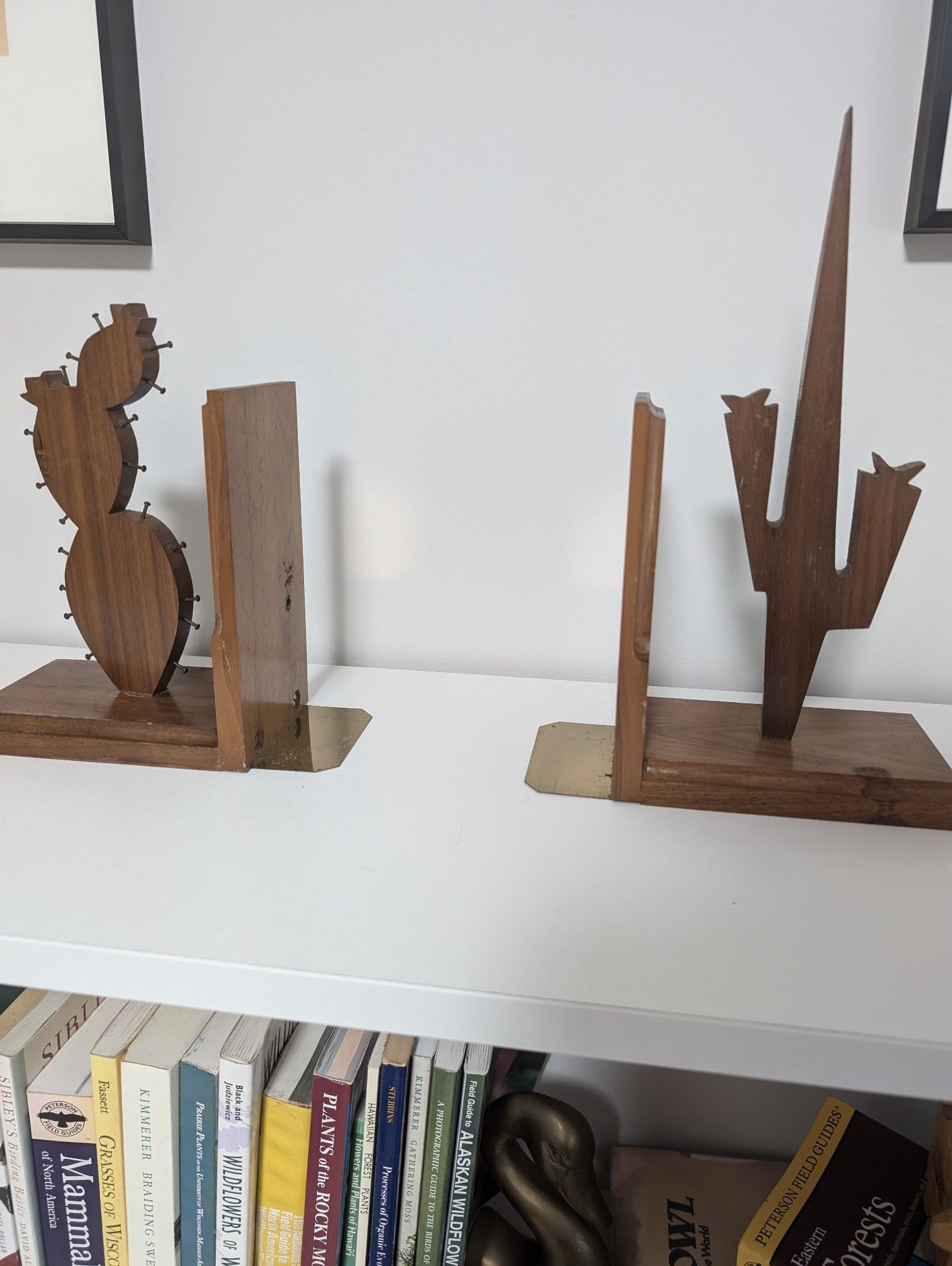 Photo of two wooden bookends that are carved into shape of cacti.