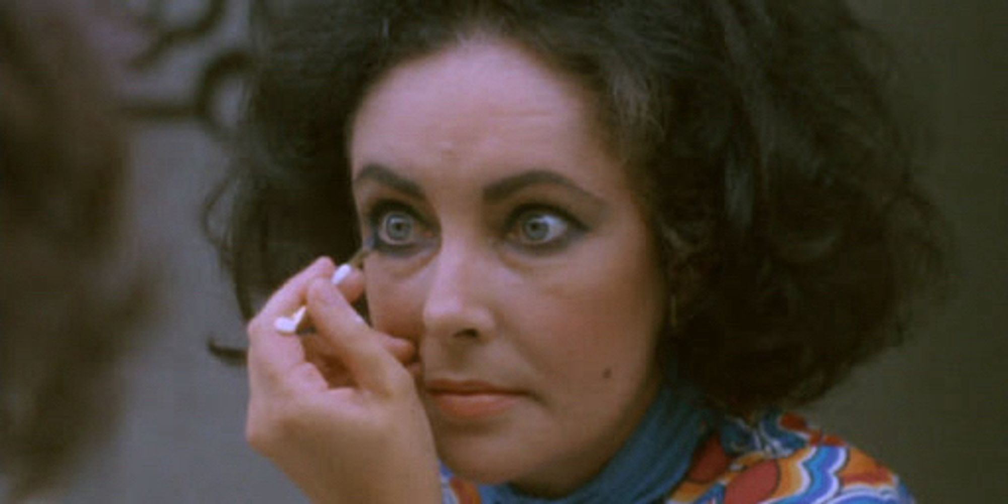 Elizabeth Taylor as Lise applying heavy make up to those massive eyes of hers.