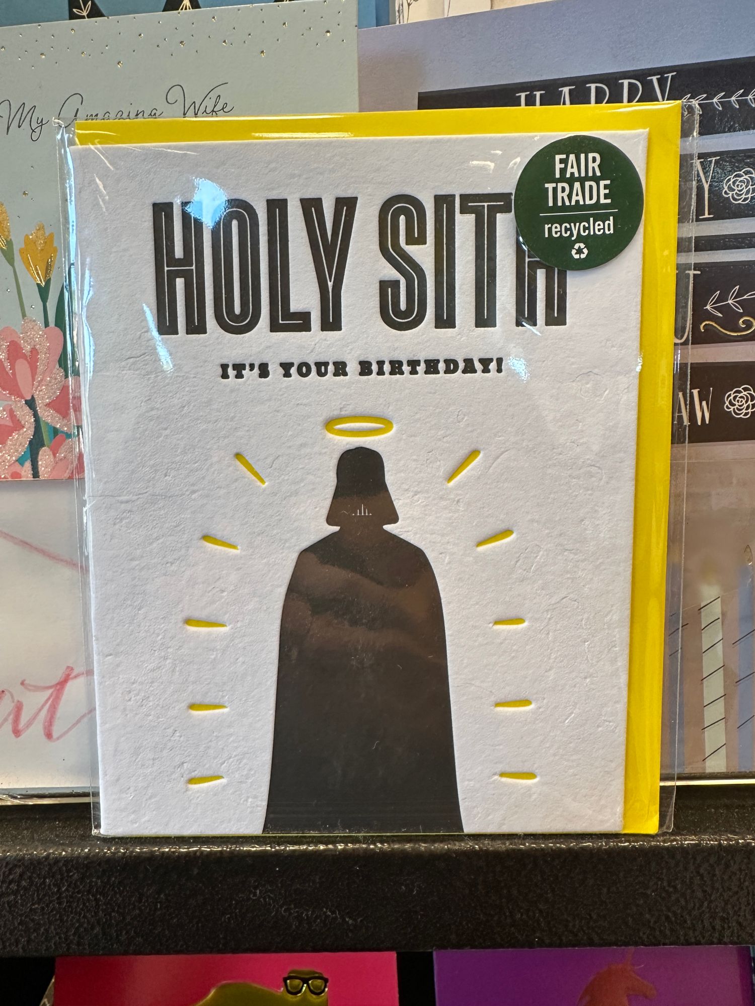 Birthday card with the silhouette of Darth Vader with a halo above his head. Words read: Holy Sith it’s your birthday!