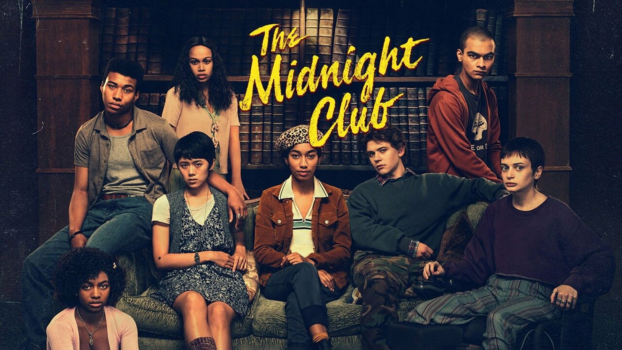 Promotional image of the cast of THE MIDNIGHT CLUB, all seated or standing in various positions and facing the camera with the title above them.