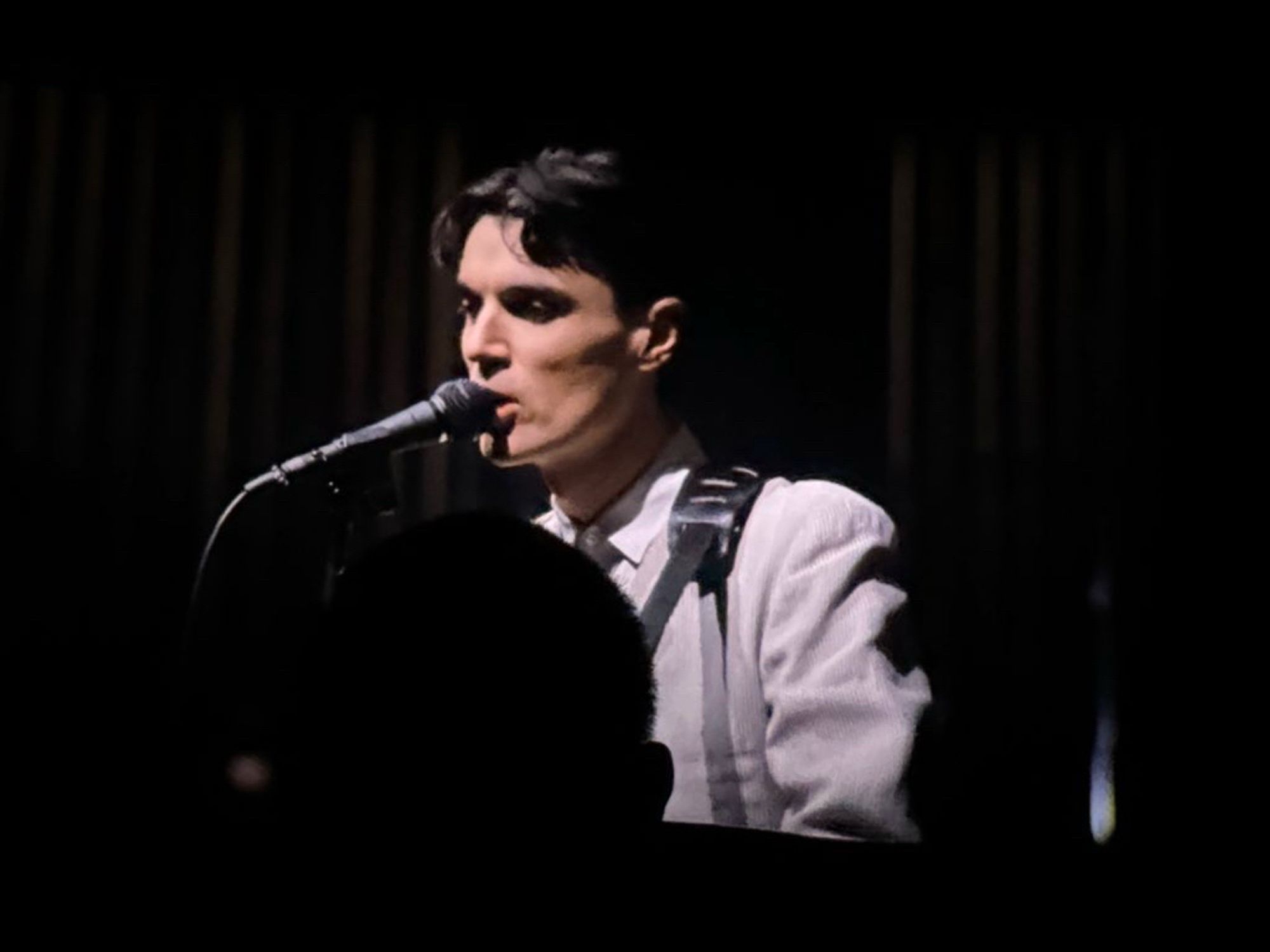 Picture of Stop Making Sense in 4k imax. David Byrne is on the screen