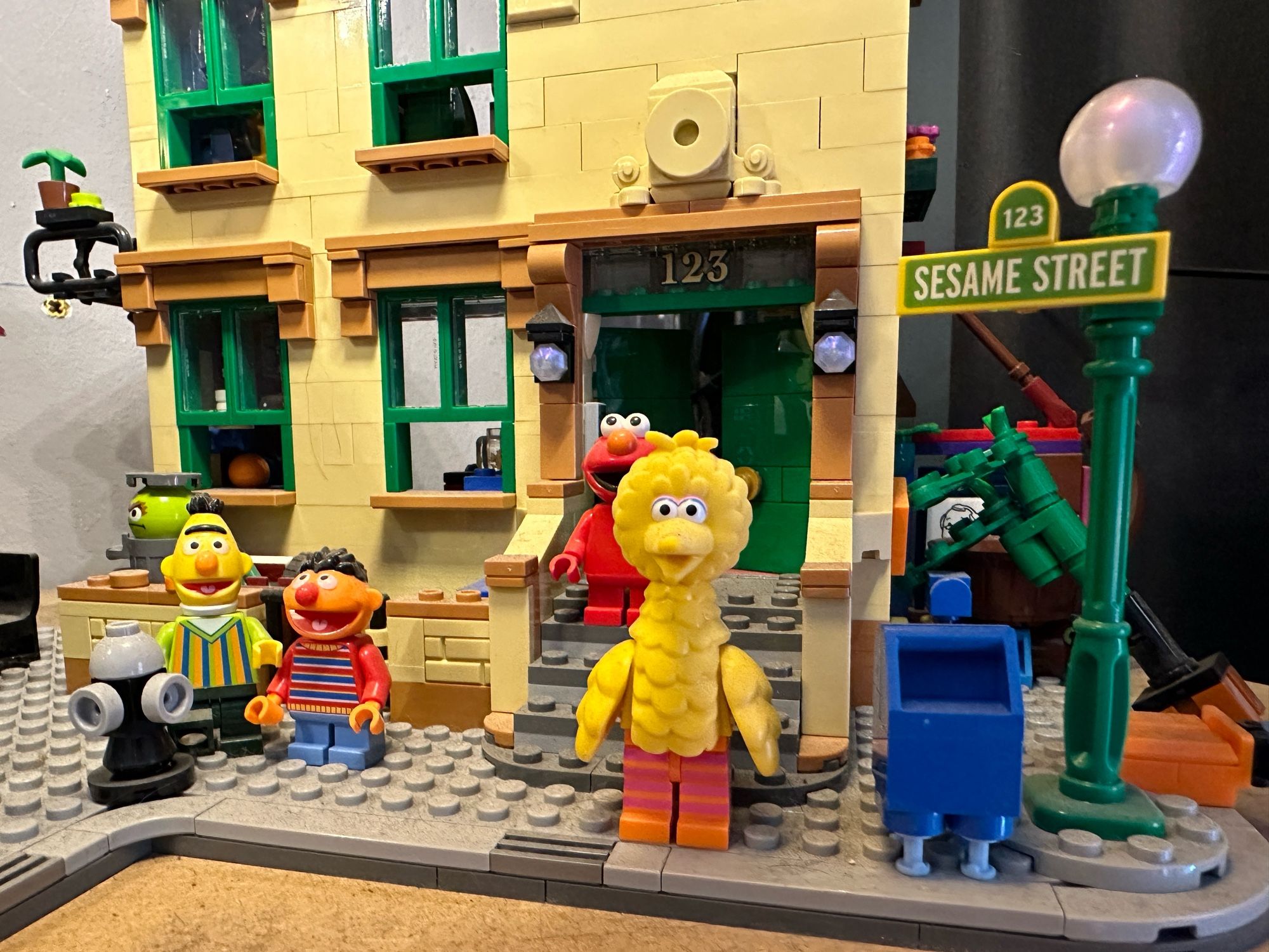 Part of the Lego Sesame Street model set, showing the door of number 123 and Big Bird standing in front.