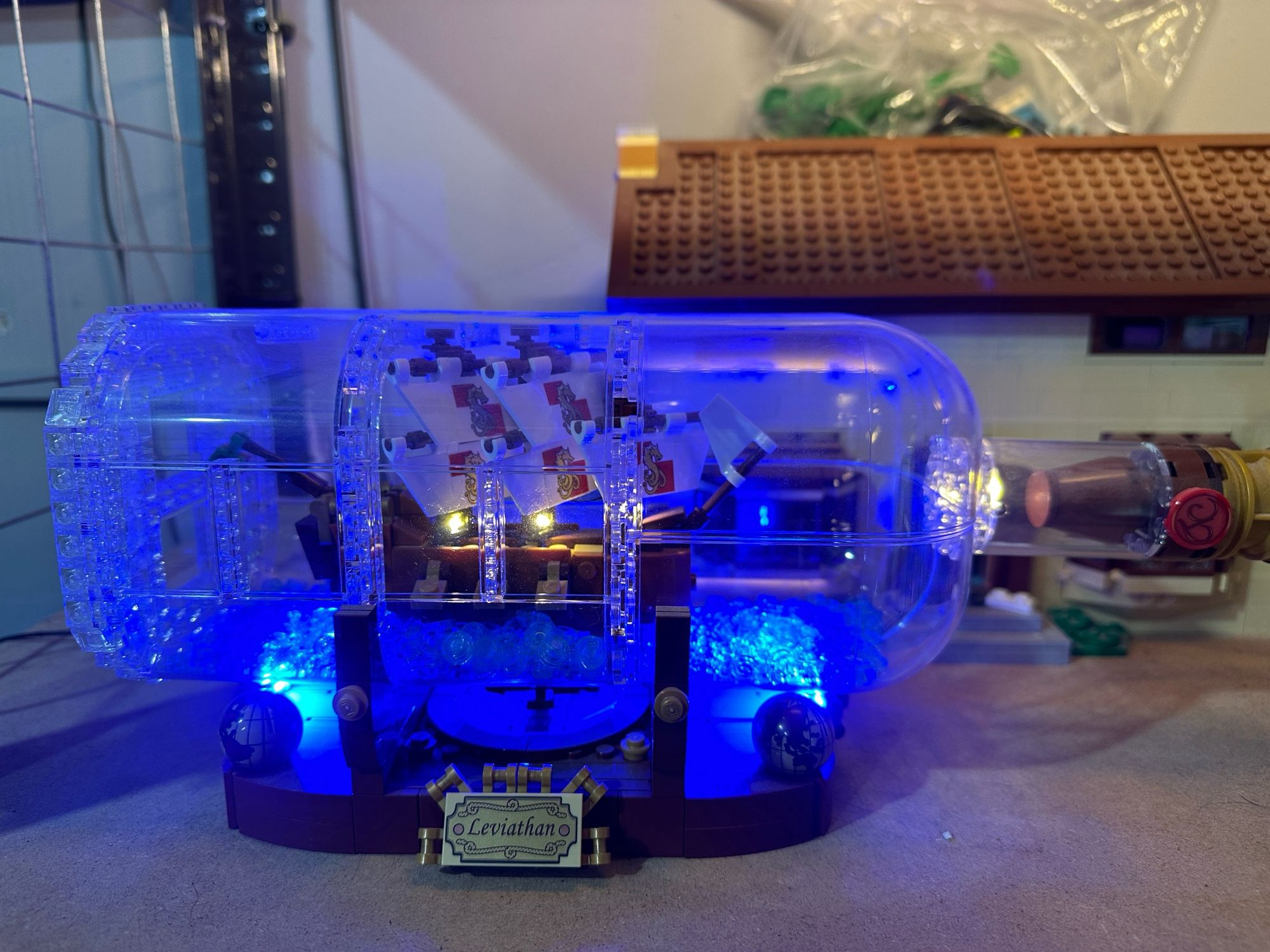 A Lego model of a tiny ship in a bottle, with lighting.