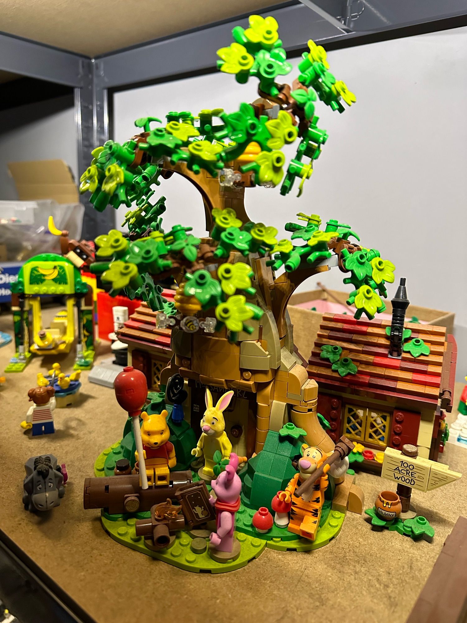 A Lego model of the Winnie The Pooh tree with all of his friends.