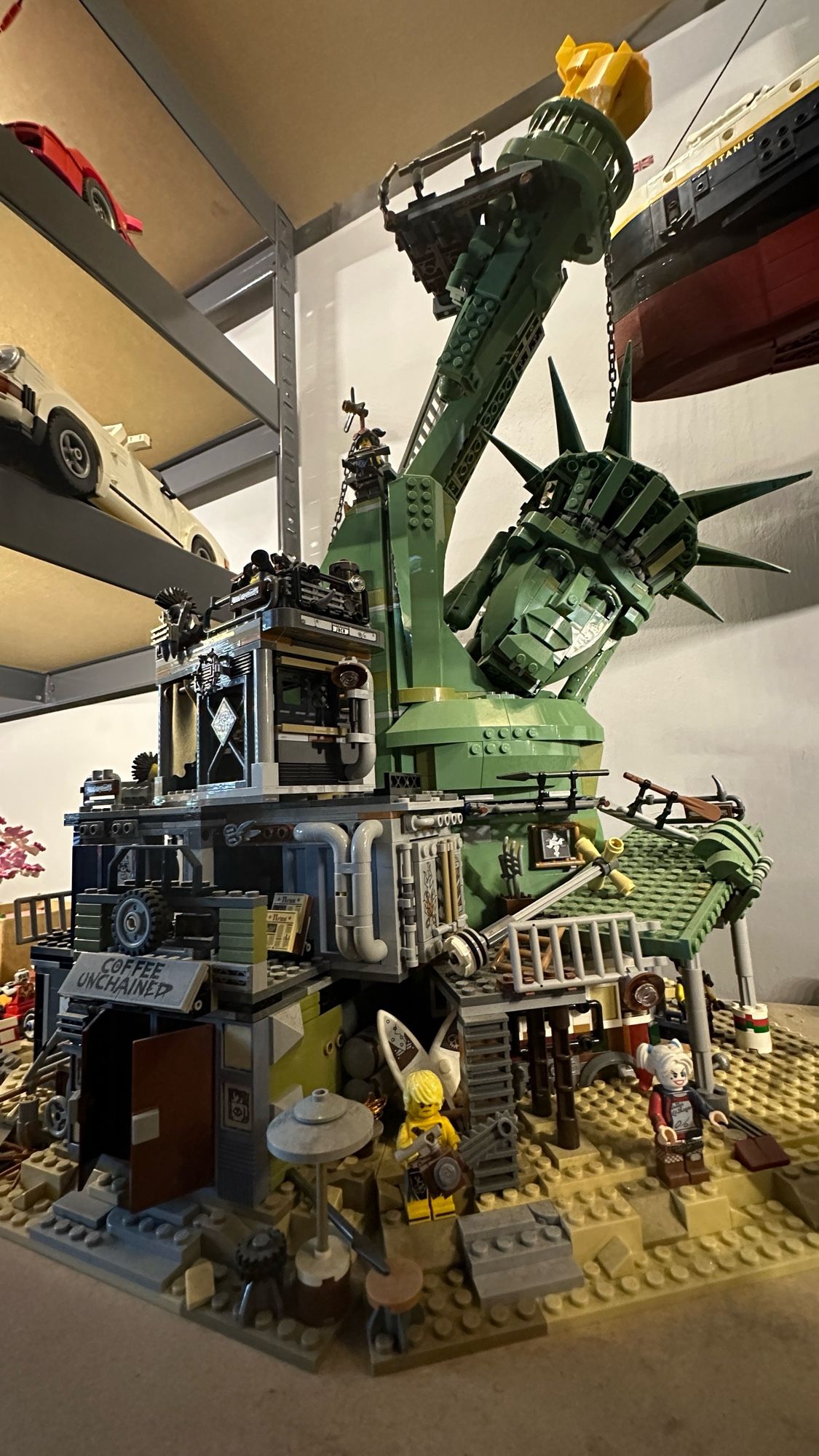 A large Lego set displaying a crumbled down Statue of Liberty in an apocalyptic New York.