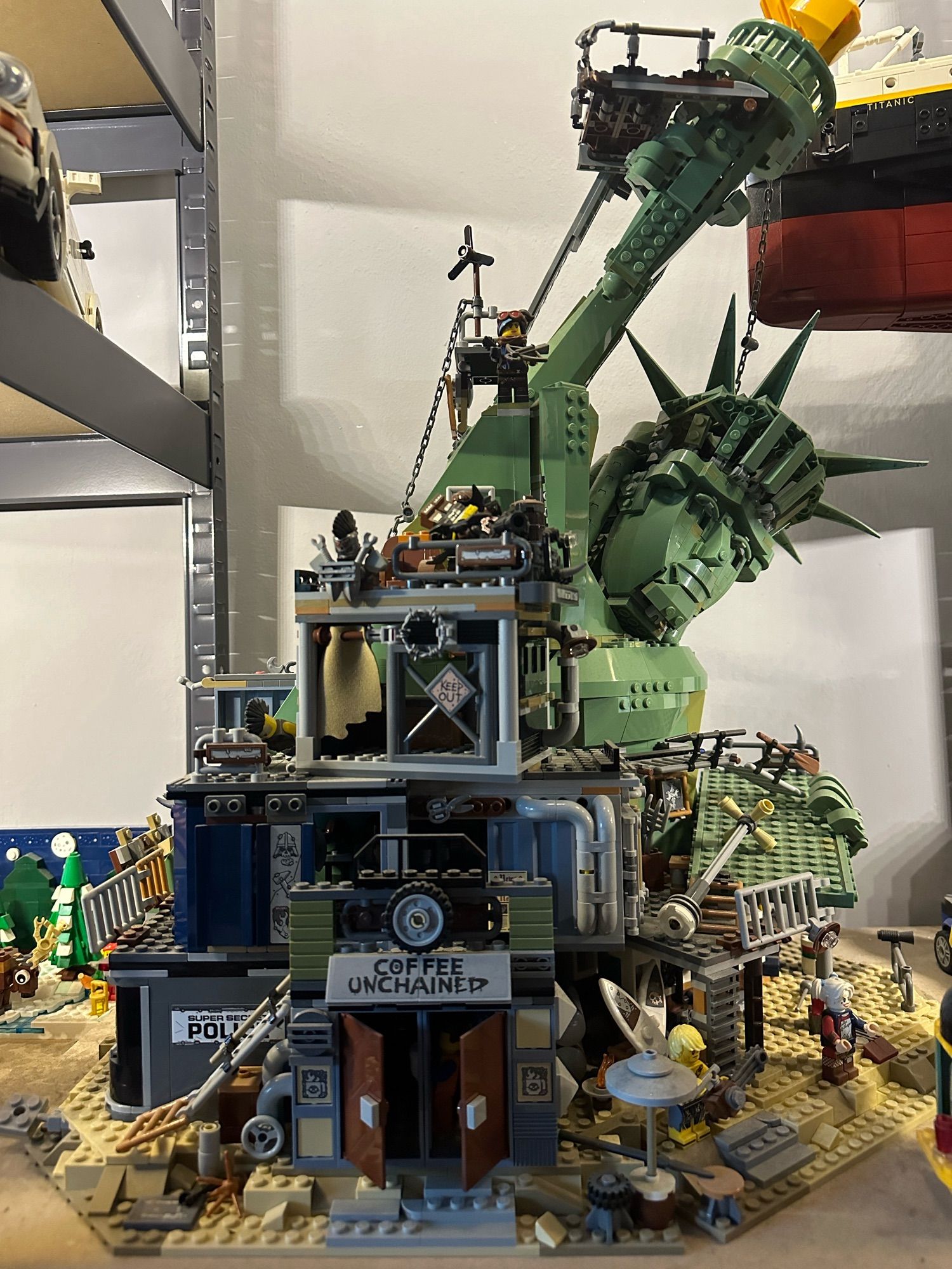 A large Lego set displaying a crumbled down Statue of Liberty in an apocalyptic New York.