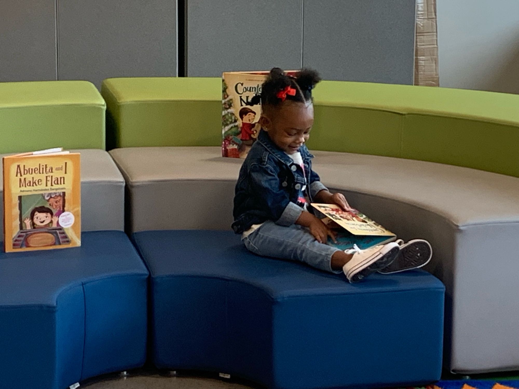 A tiny library patron reads my book COUNTDOWN FOR NOCHEBUENA