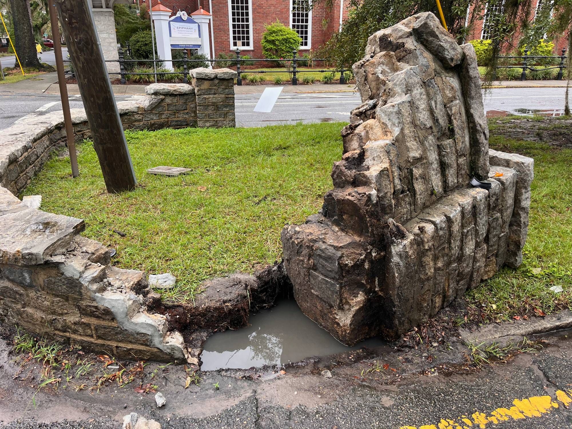 A photo of an architectural feature, which was erected in the early 1900s, at the east entrance to Savannah Georgia's historic Chatham Crescent neighborhood. It's been hit by a motor vehicle driver. Repairs after another motorist hit it about two years ago are visible.