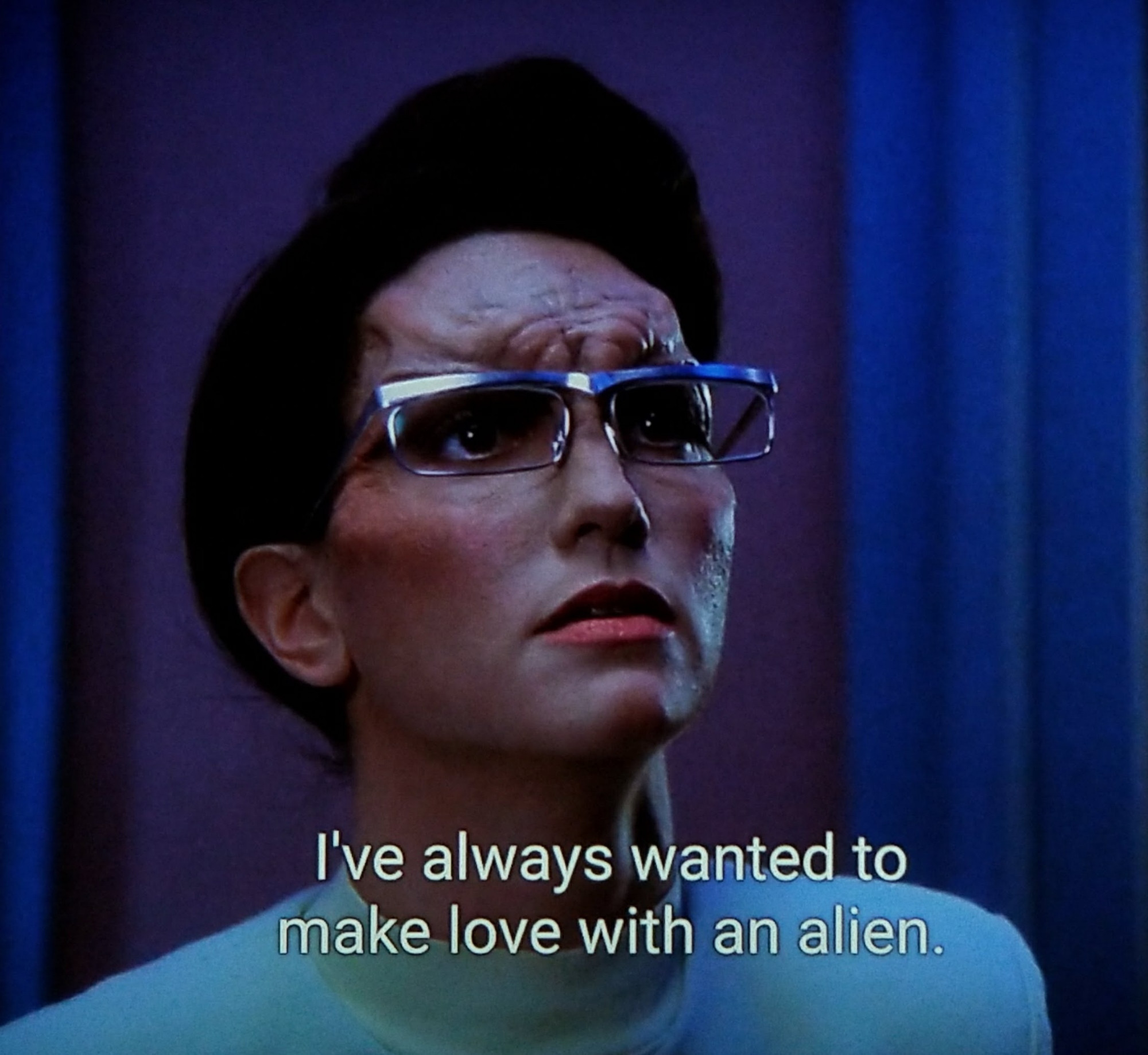 Star Trek The Next Generation scene. Close up on a humanoid alien woman with some ripply looking forehead loaf. She's looking up hopefully and expectantly. Looks a lot like Lilith from Cheers but I'm sure that's just a coincidence. Closed caption reads, "I've always wanted to make love to an alien."