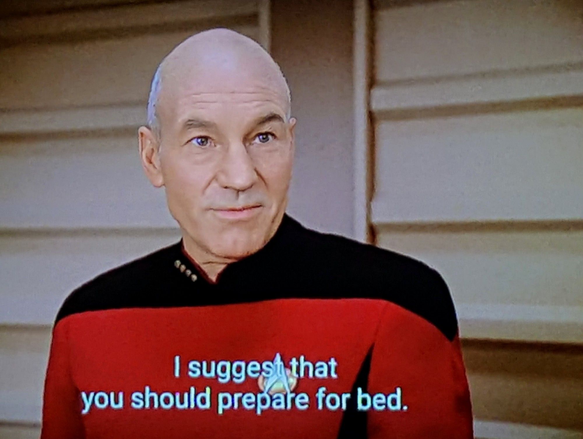 TNG scene. Captain Picard is standing on the bridge and speaking, nothing else too crazy going on here. Closed caption reads, "I suggest that you should prepare for bed."