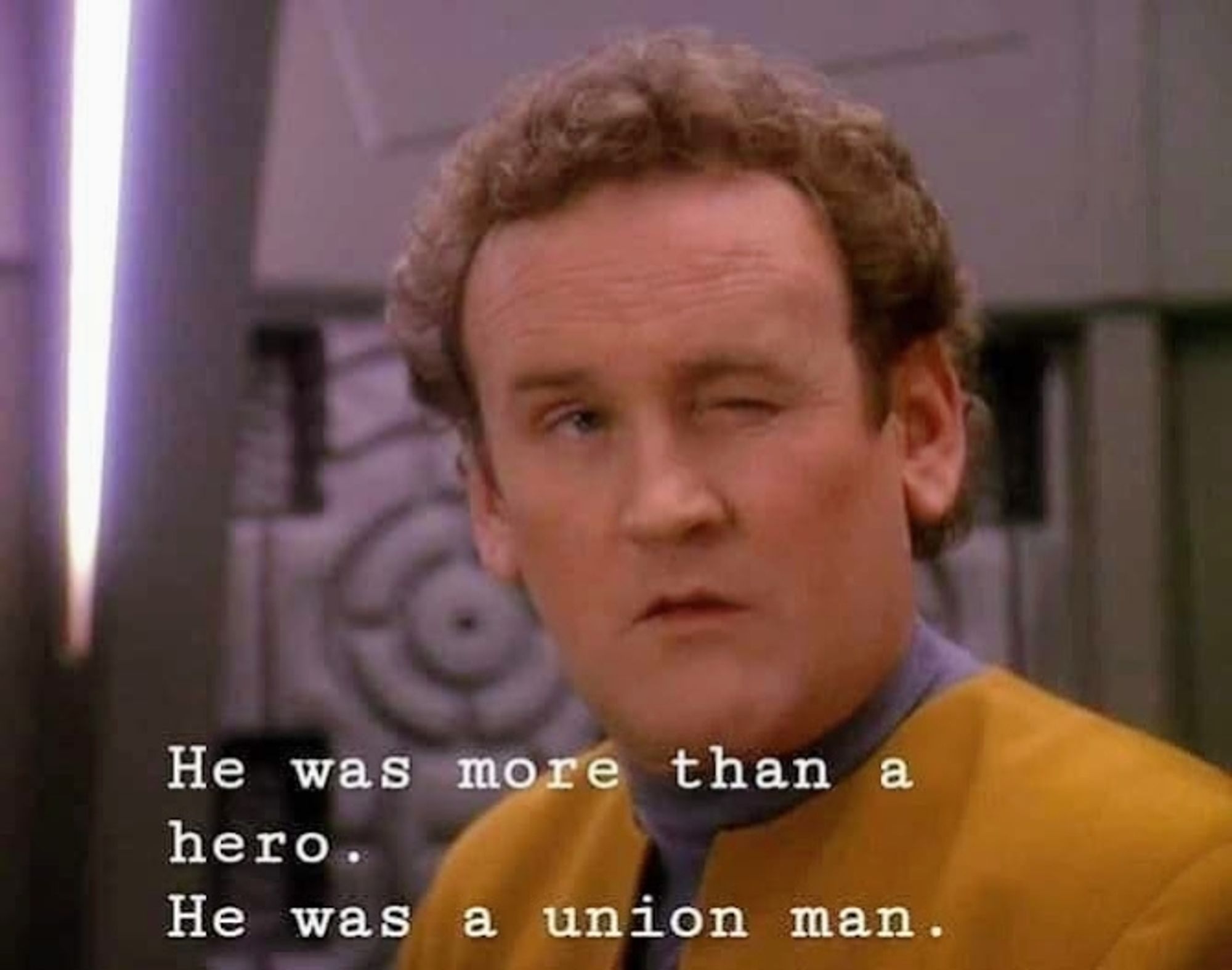 Chief Miles Edward O'Brien, who could strangle you with a cordless phone if he wanted to, is pictured. Chief O'Brien, who can kill 2 stones with 1 bird, is facing the camera and winking. O'Brien, who can dribble a bowling ball, is on DS9 station and wearing his classic gold uniform, and has the energy of a man who is walking away from an explosion without looking backwards at it. Closed caption reads, "He was more than a hero. He was a union man."