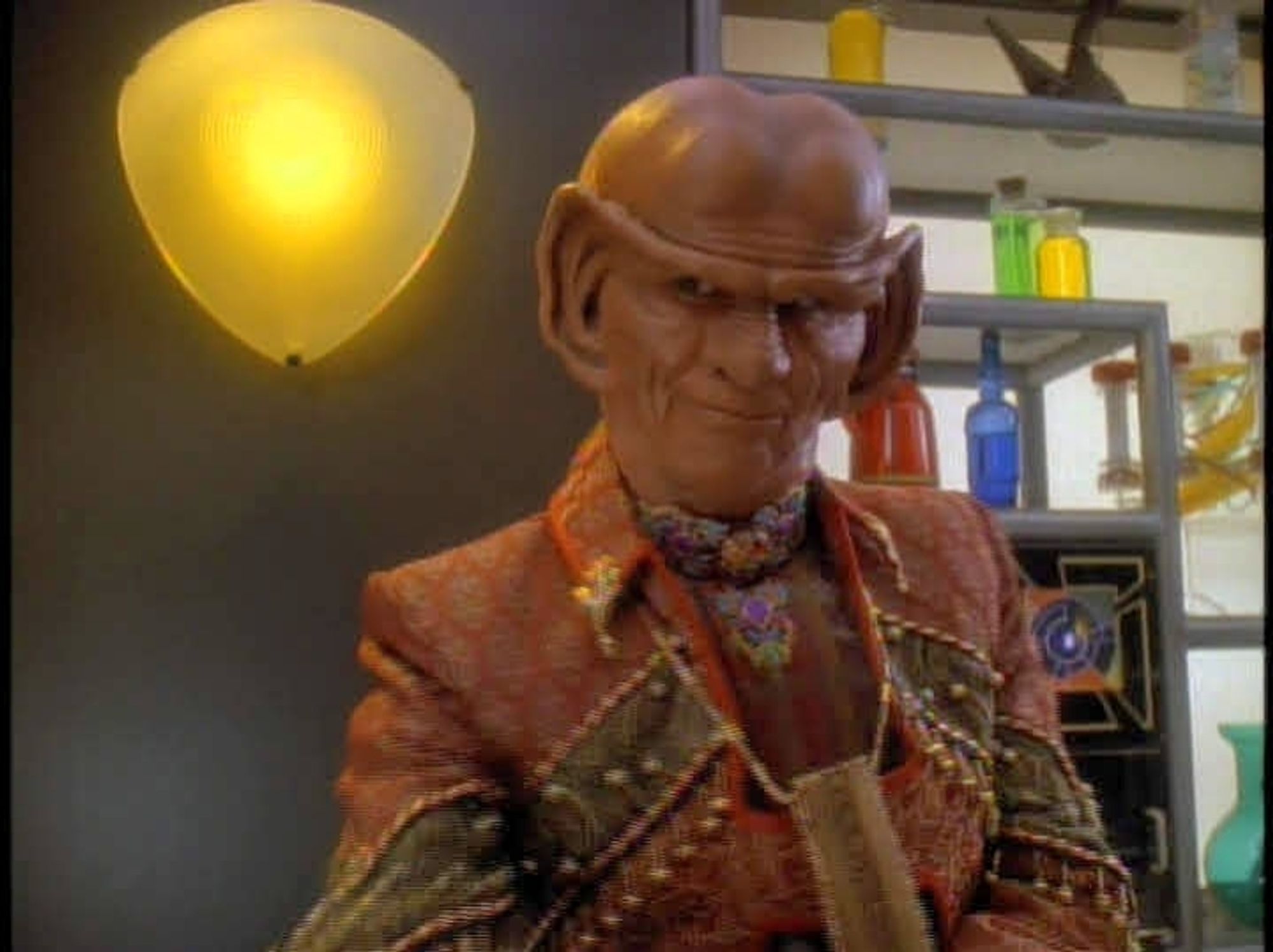 Brunt, a ferengi with big giant ears that form a unibrow of ears and a big bulbous bald head is being cutesy.