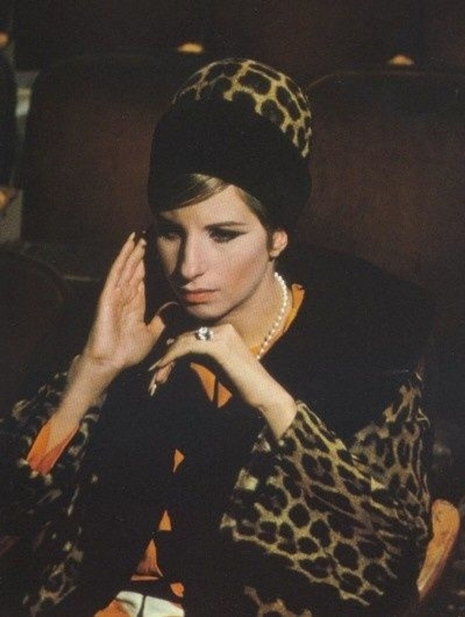 Barbra Streisand with huge hair wrapped in a leopard print scarf