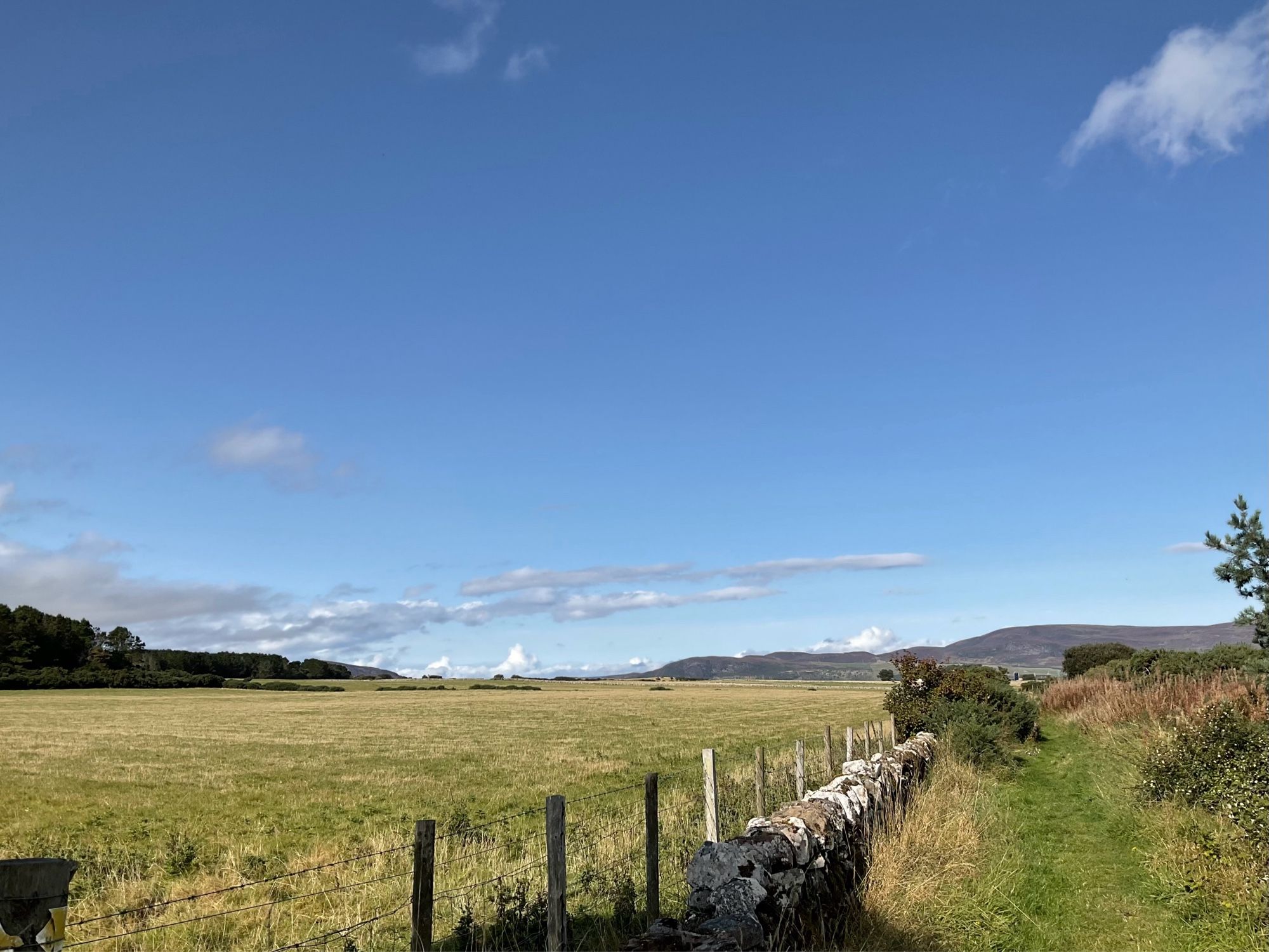 Blue sky, hills, field, stone wall, footpath