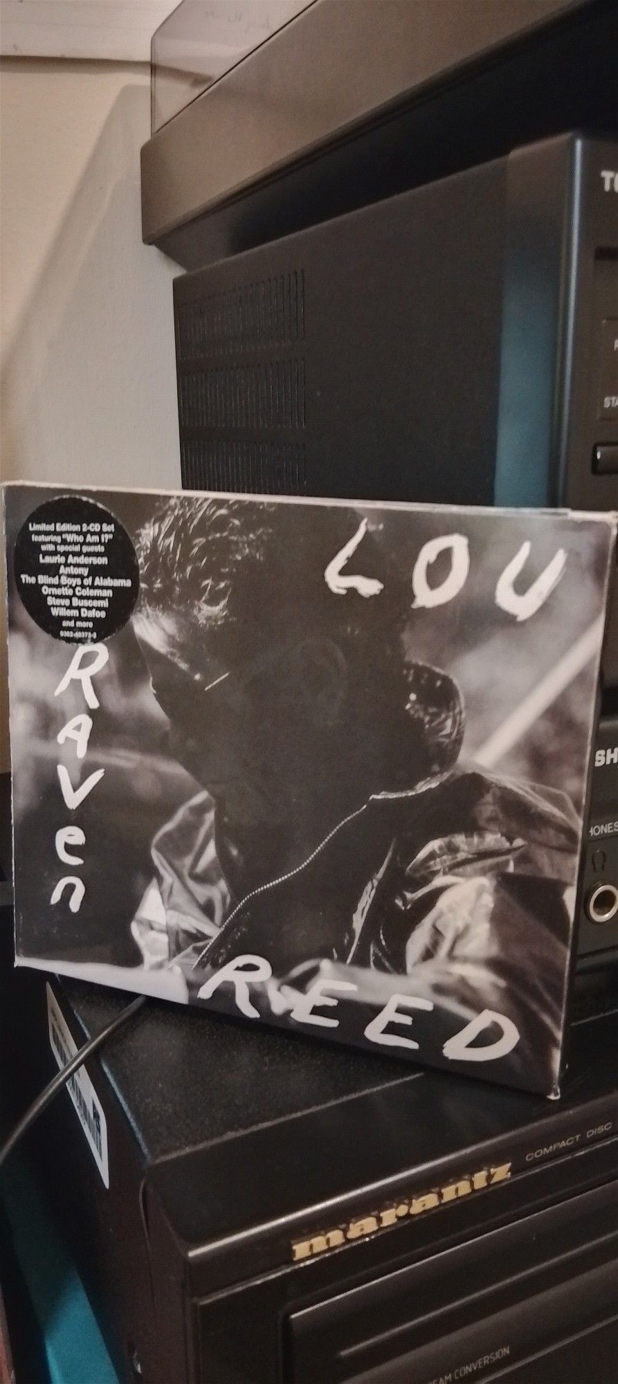 Case of The Raven album propped on top of the CD player, featuring a monochrome photo of Lou wearing a leather jacket in the sunlight.