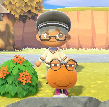 Silver haired villager looking at the camera with Wart Jr. In the foreground wearing glasses and reading a book