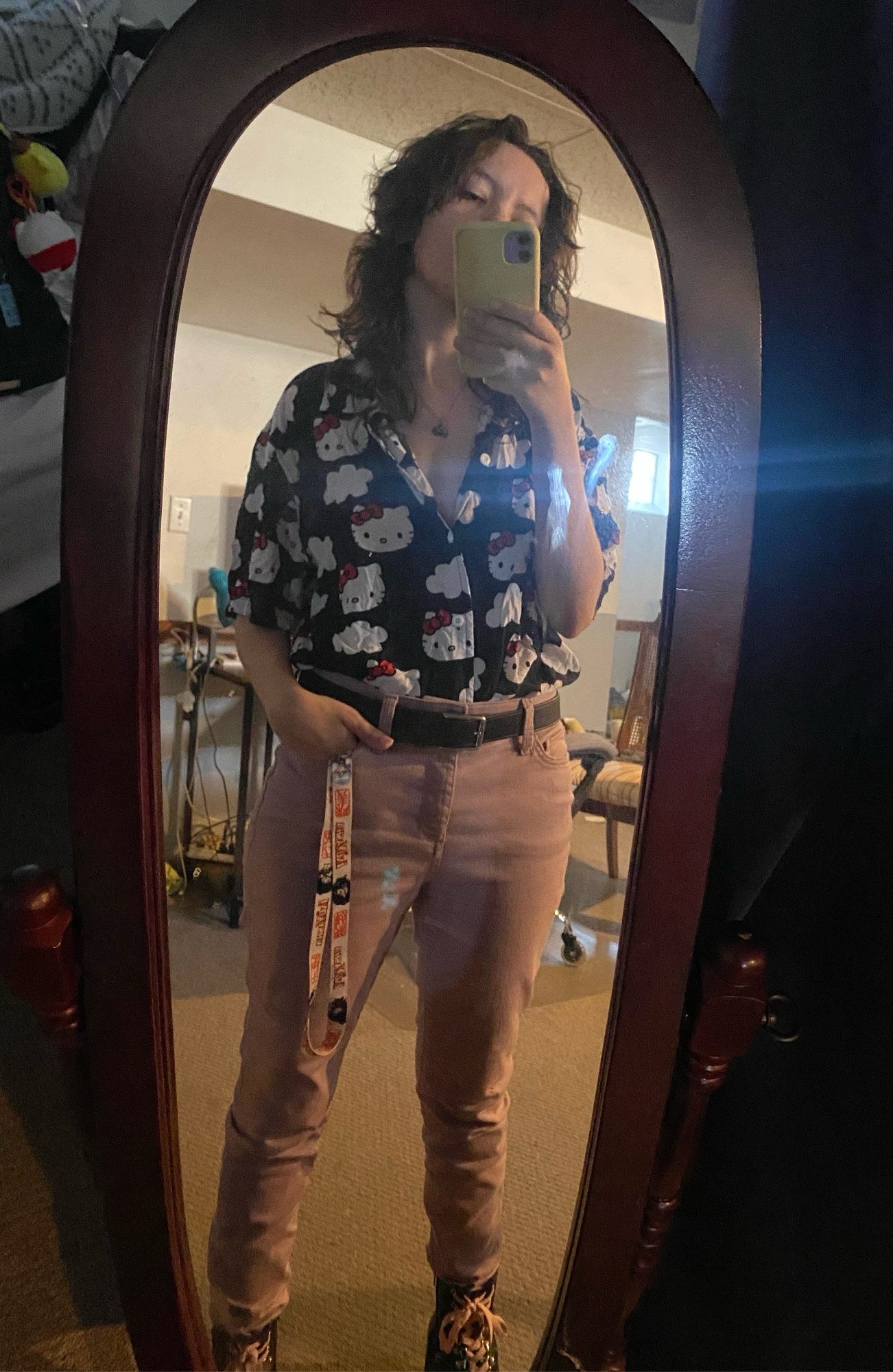 mirror selfie of Ollie! wearing a Hello Kitty button-down shirt and some dusty pink pants. he looks quite handsome