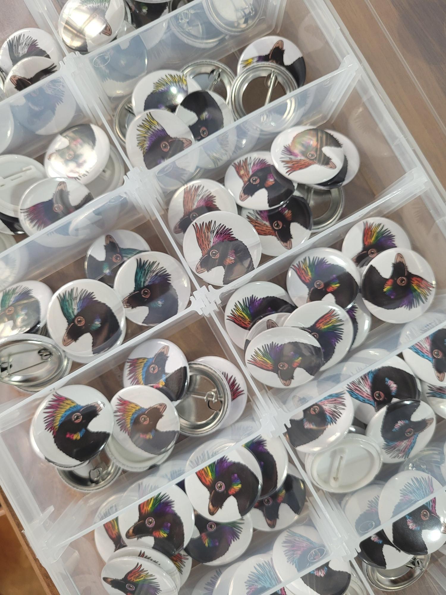 A photos of a box full of different pride badges
