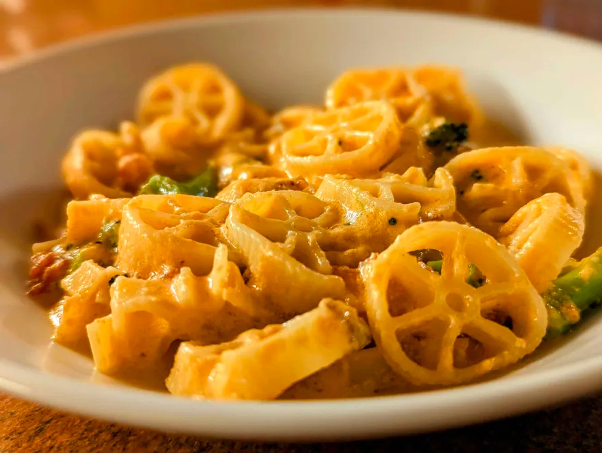 A bowl of bacon and broccoli mac (wheels) and cheese