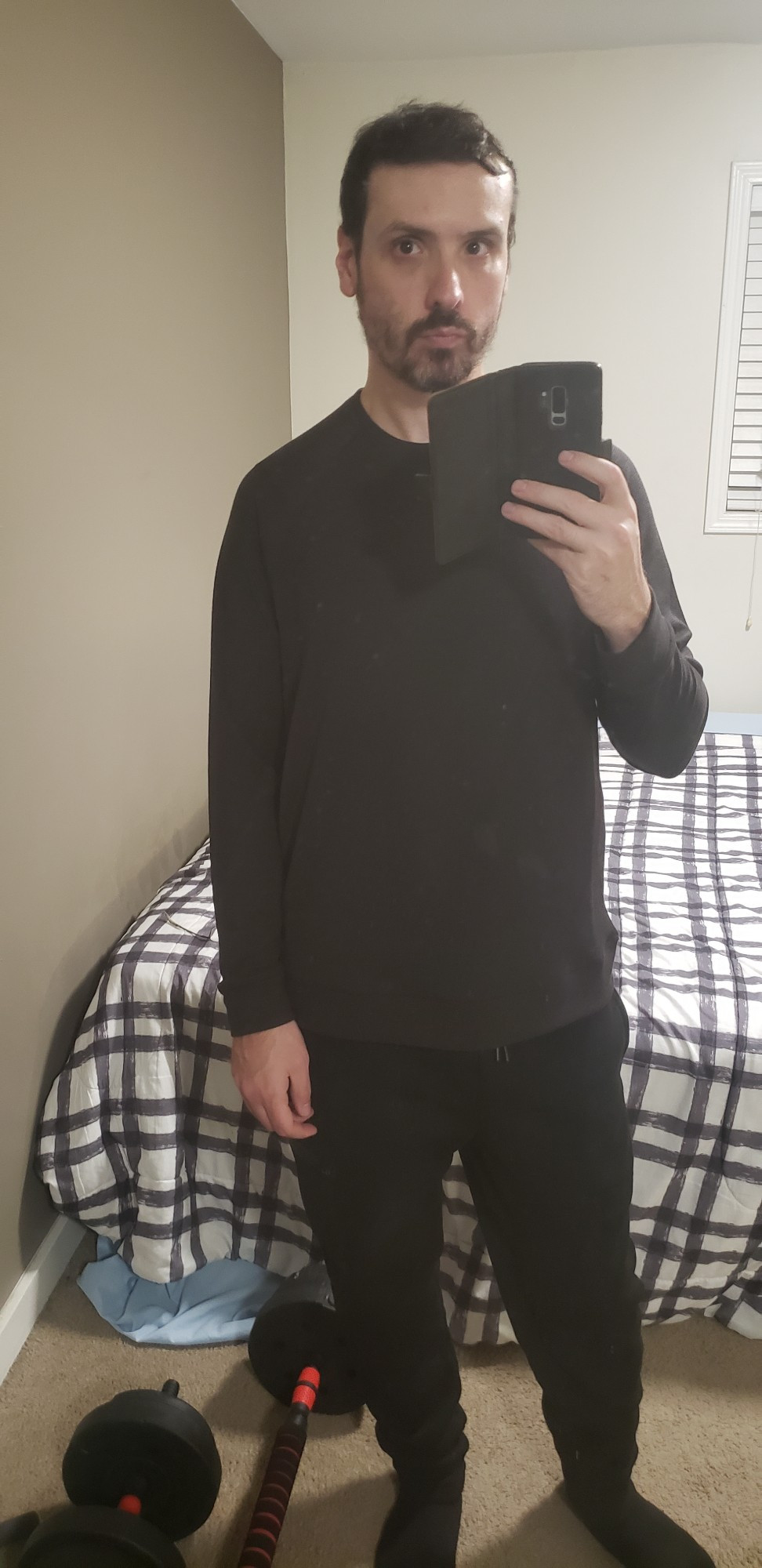 Just me in front of my mirror holding my phone in black clothes.