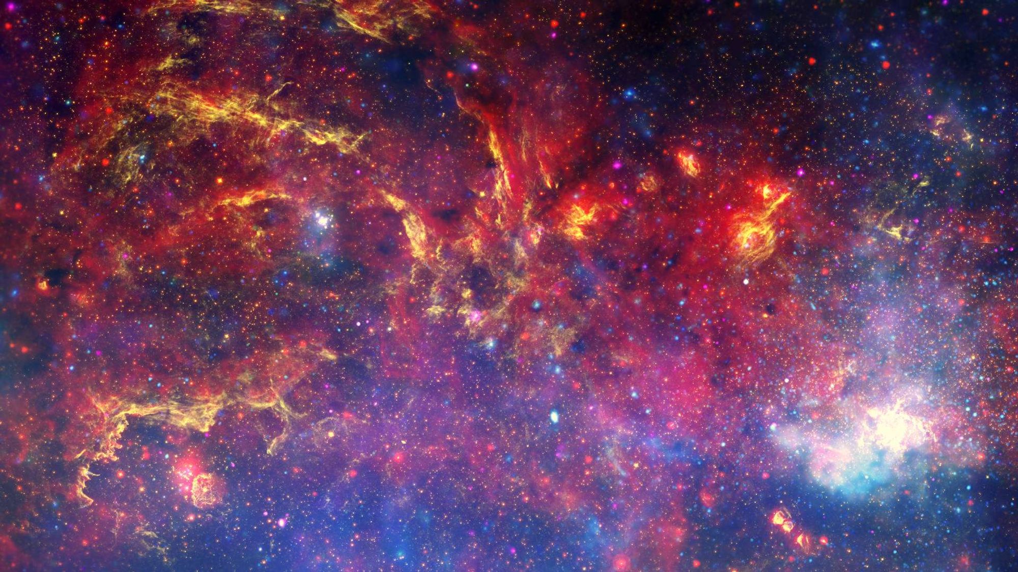 Data from NASA's Great Observatories has been combined to produce this unprecedented image of the central region of the Milky Way.  Near-infrared light from Hubble (yellow) outlines energetic regions where stars are being born.  Infrared data from Spitzer (red) show glowing clouds of dust containing complex structures.  And, X-rays from Chandra (blue and violet) reveal gas heated to millions of degrees by stellar explosion and outflows from the Galaxys supermassive black hole.