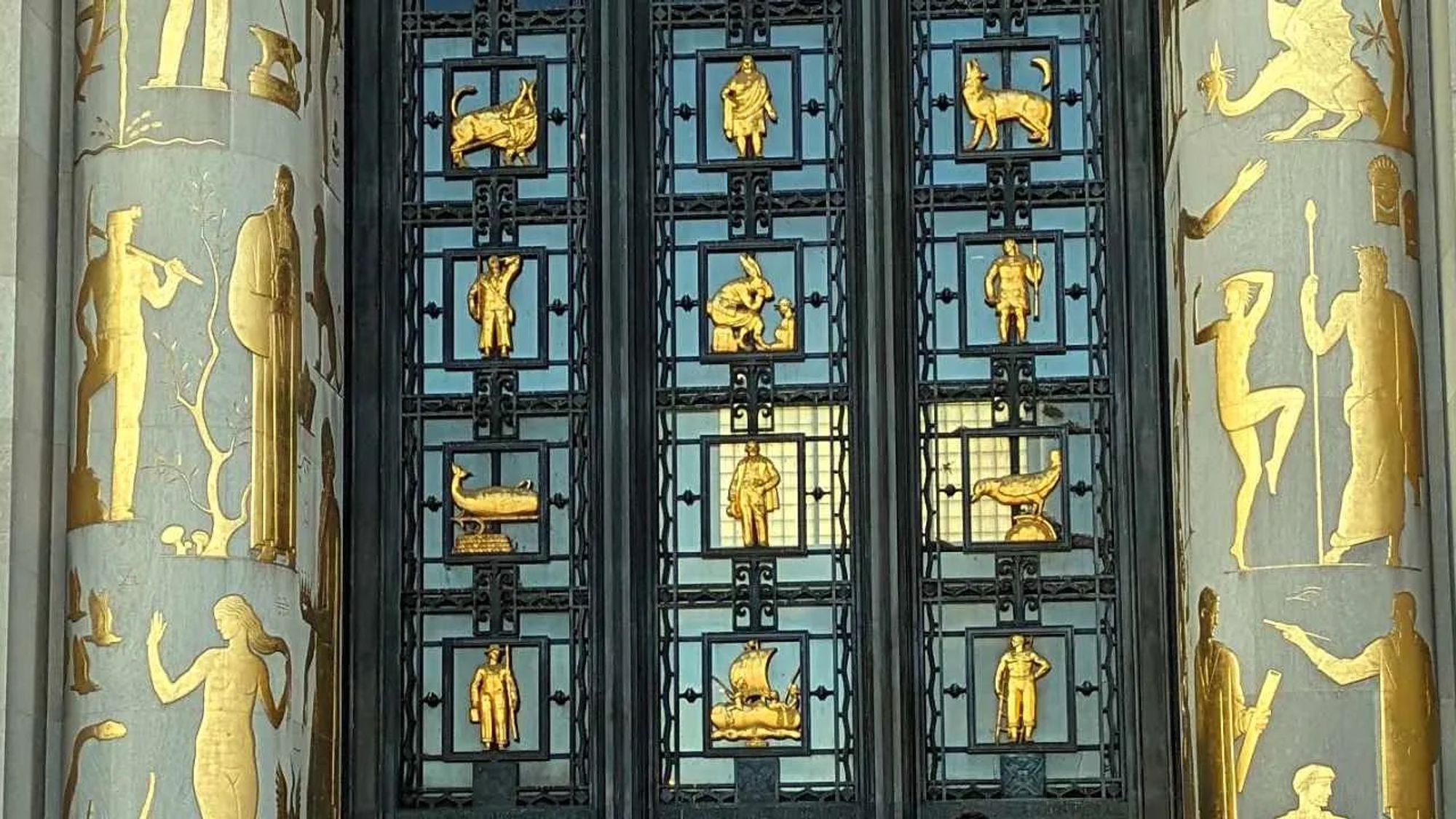 Gilded figures on the facade of the Brooklyn Public Library.