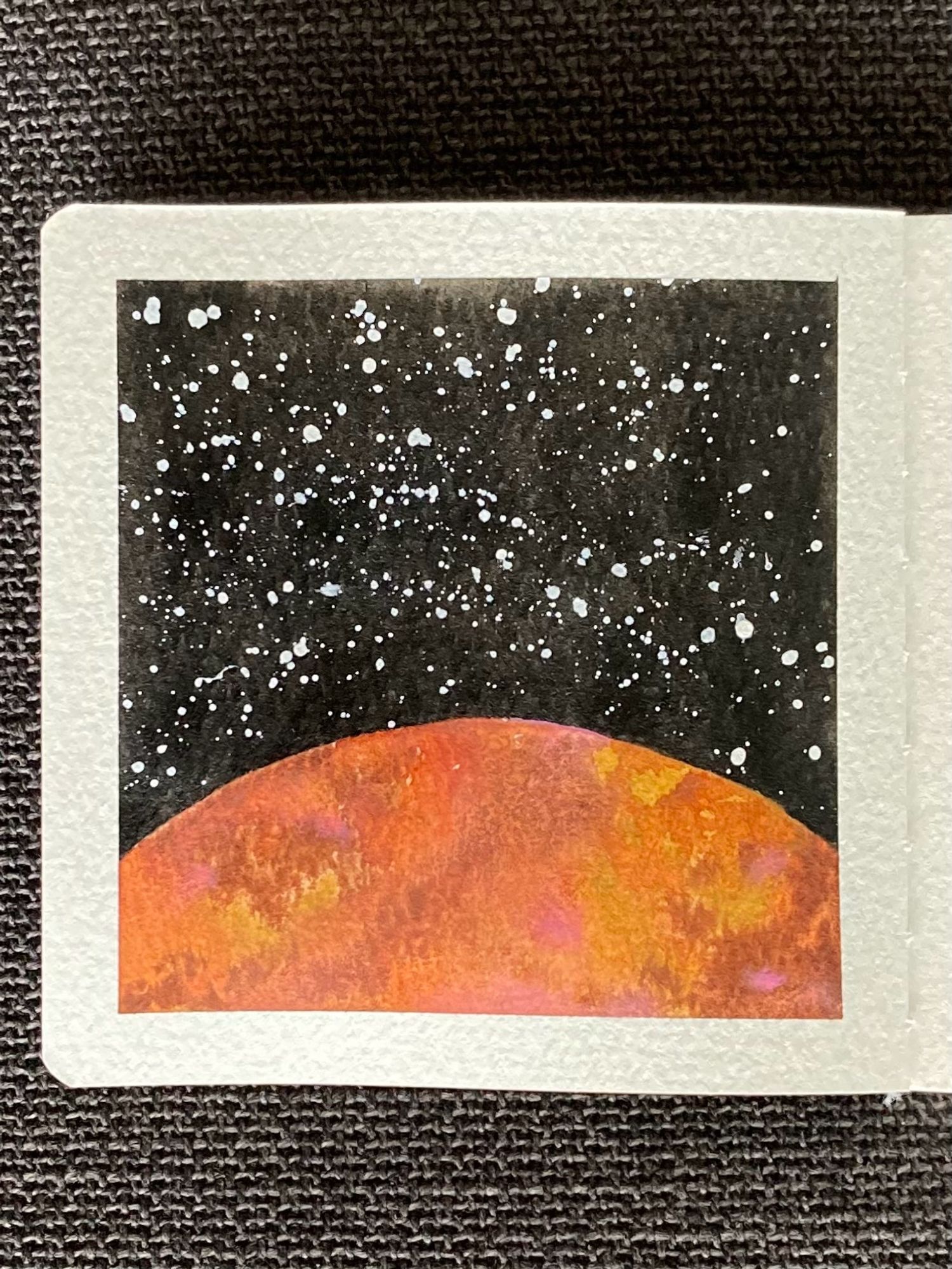 A watercolor painting of a planet in space. The planet takes up the bottom third of the painting. Its surface is mottled with orange, yellow, burgundy and pink. Behind the planet is the vastness of space, dotted with many stars.