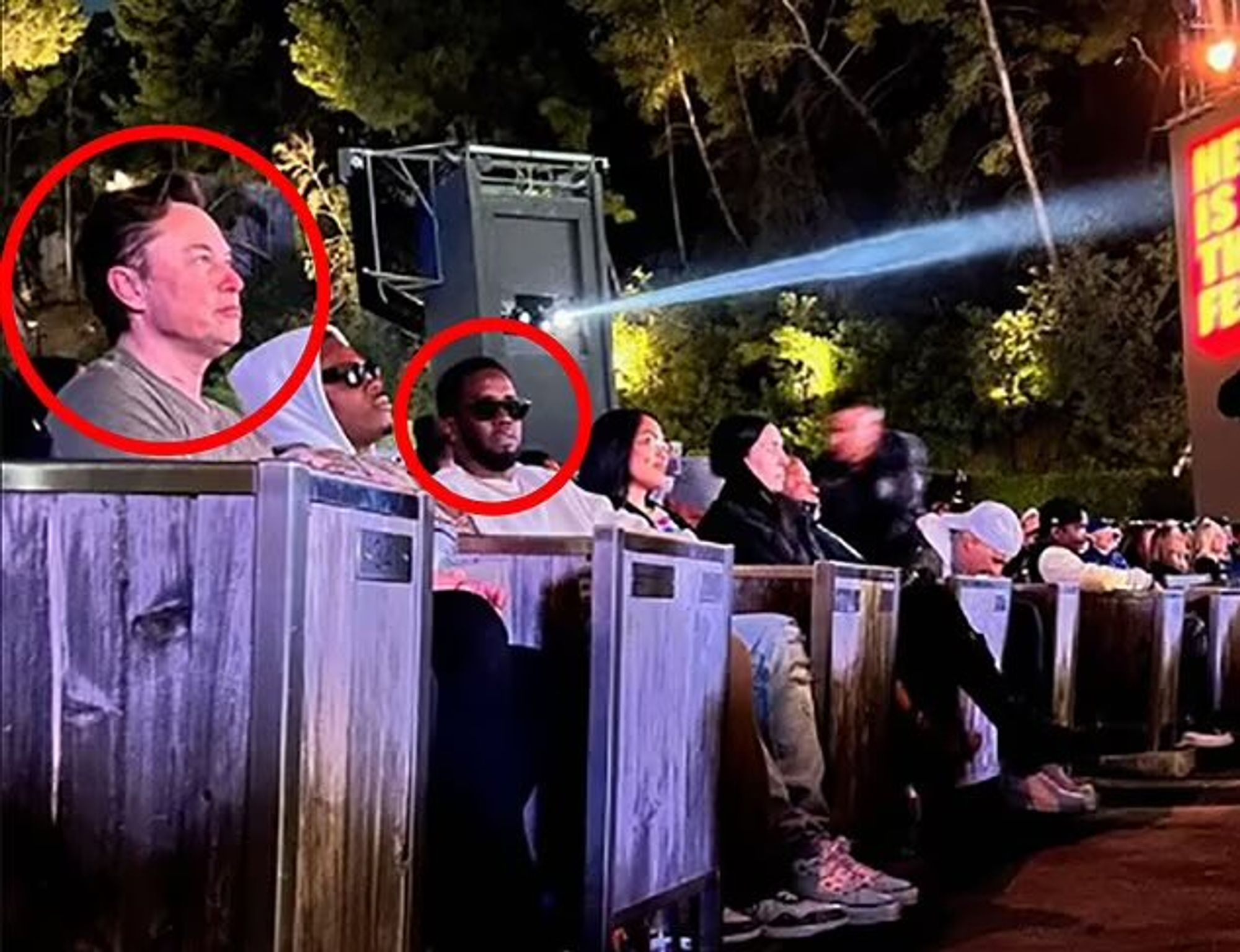 Elon Muck sitting at an event with Diddy