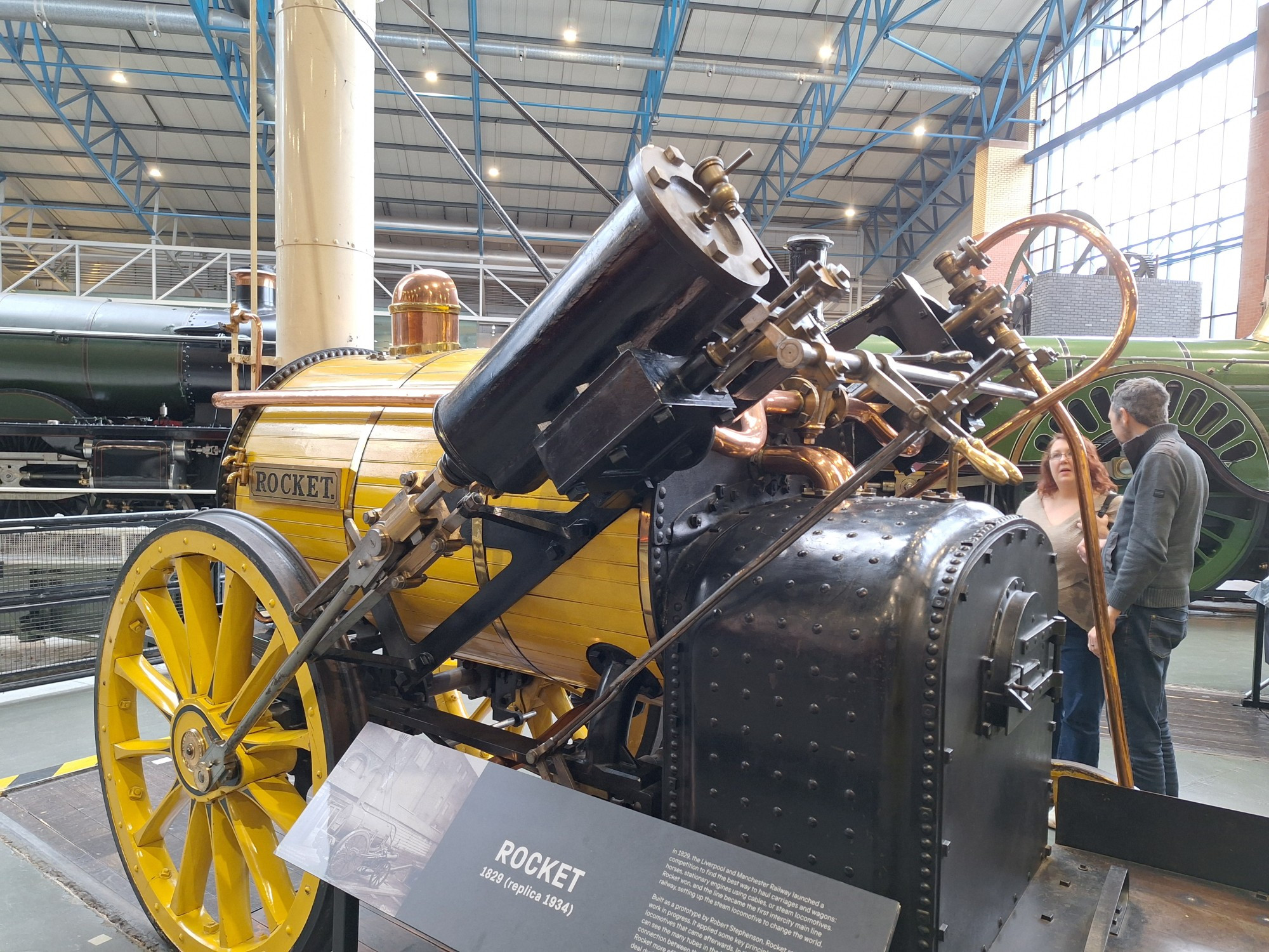 Very cool yellow train with largw diagonally-mounted pistons attached to the wheels