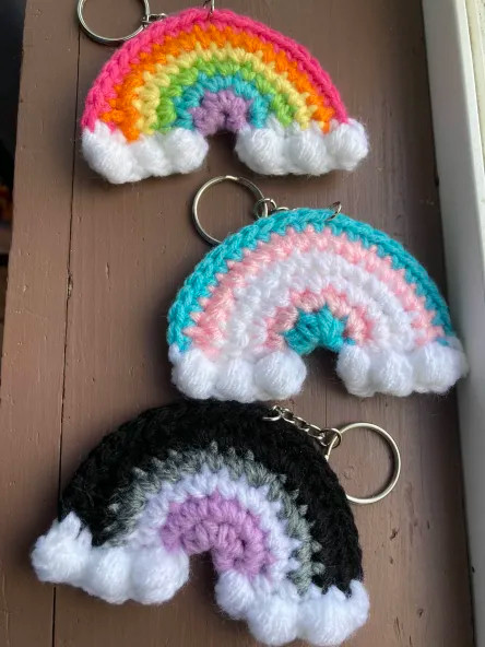 Three crochet pride keychain rainbows - pride rainbow, trans, and ace flags!