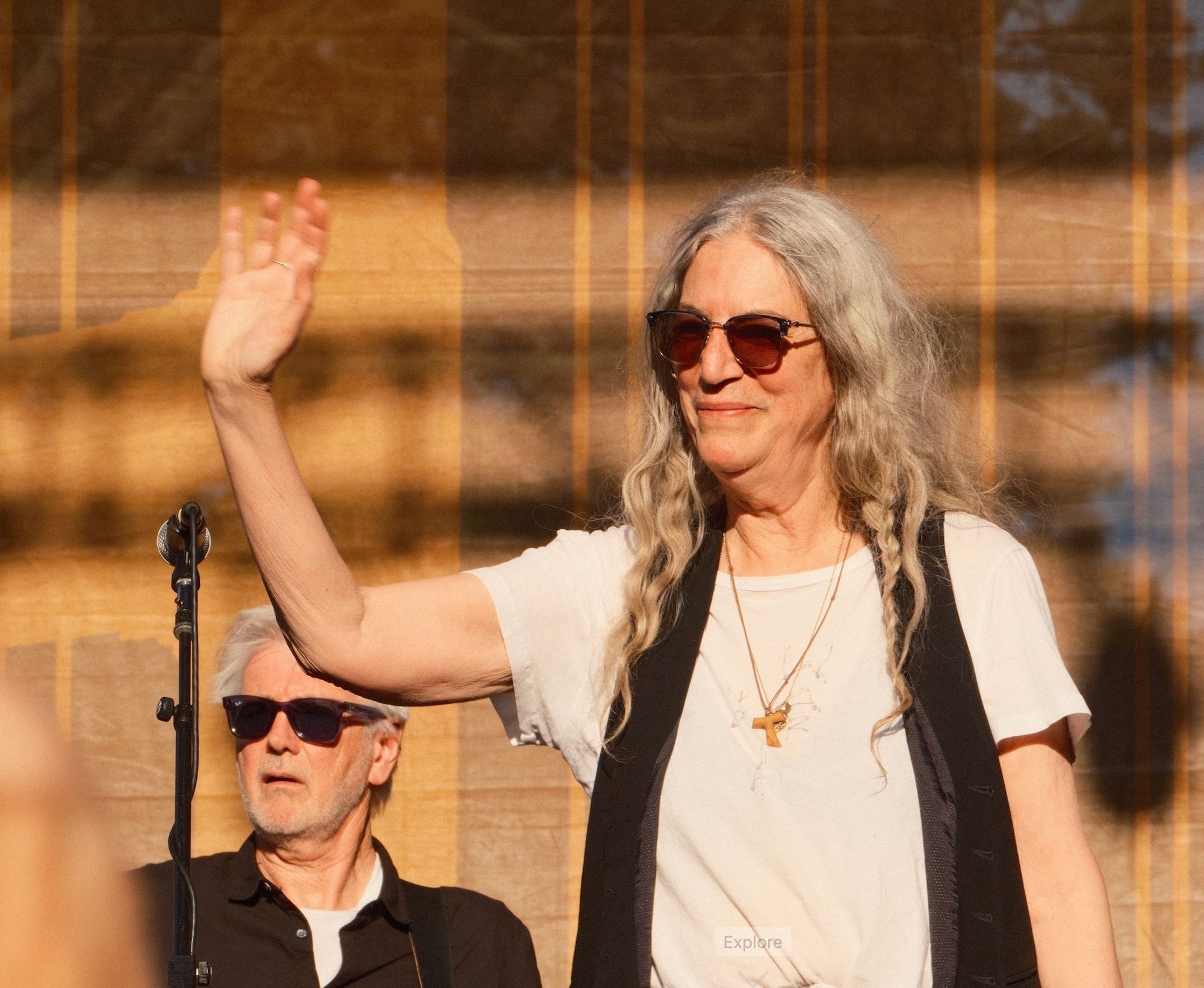 a smiling Patti Smith waves in a photo taken today at Hardly Strictly Bluegrass by me