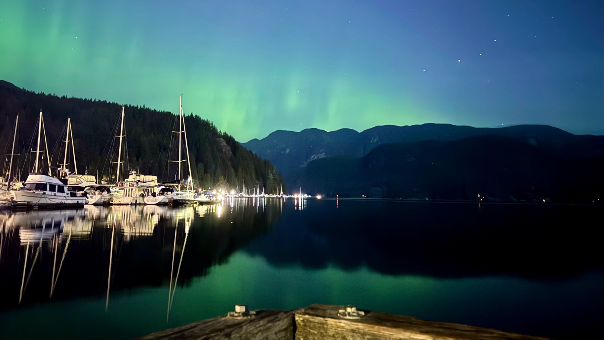 Aurora Borealis over and reflecting off the waters of Deep Cove in Metro Vancouver BC