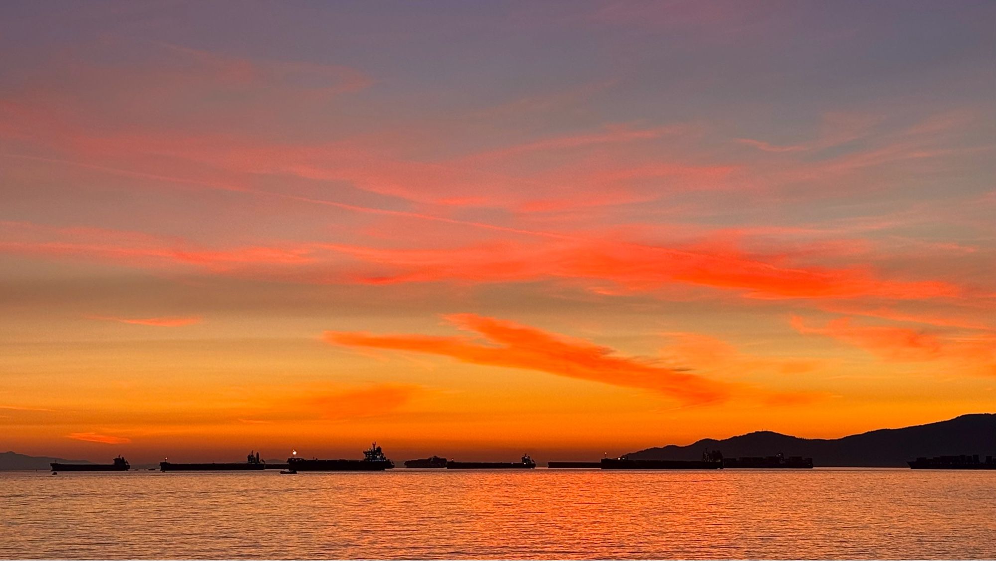 beautiful sunset over the Salish Sea as seen from English Bay beach in Vancouver BC