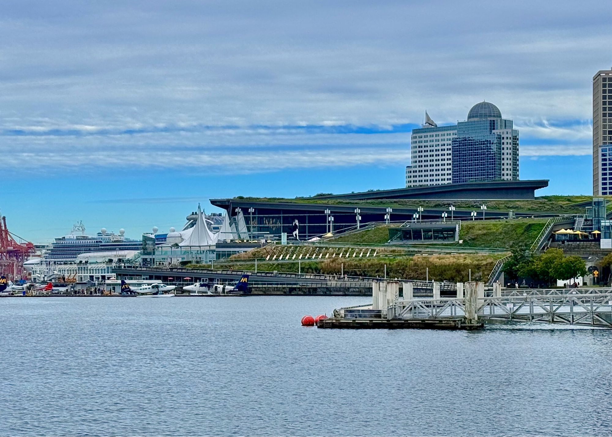 A view of Vancouver’s Convention Centre looking east at blue sky and things cloud over from the west