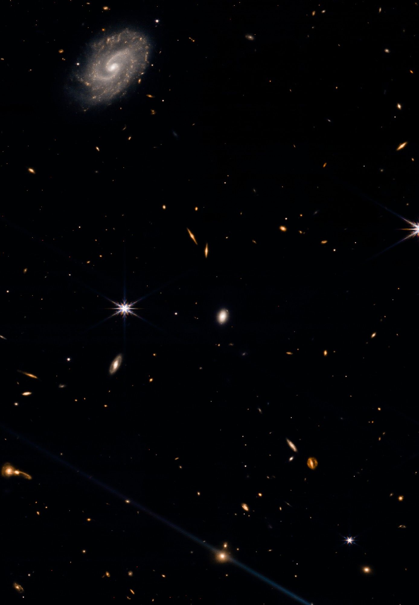 The image you provided is a NIRCam image of SPT2146-55. It shows a massive galaxy cluster with hundreds of galaxies, including a large number of lensed galaxies. The cluster is located about 12 billion light-years away from Earth. The image was taken by the James Webb Space Telescope.