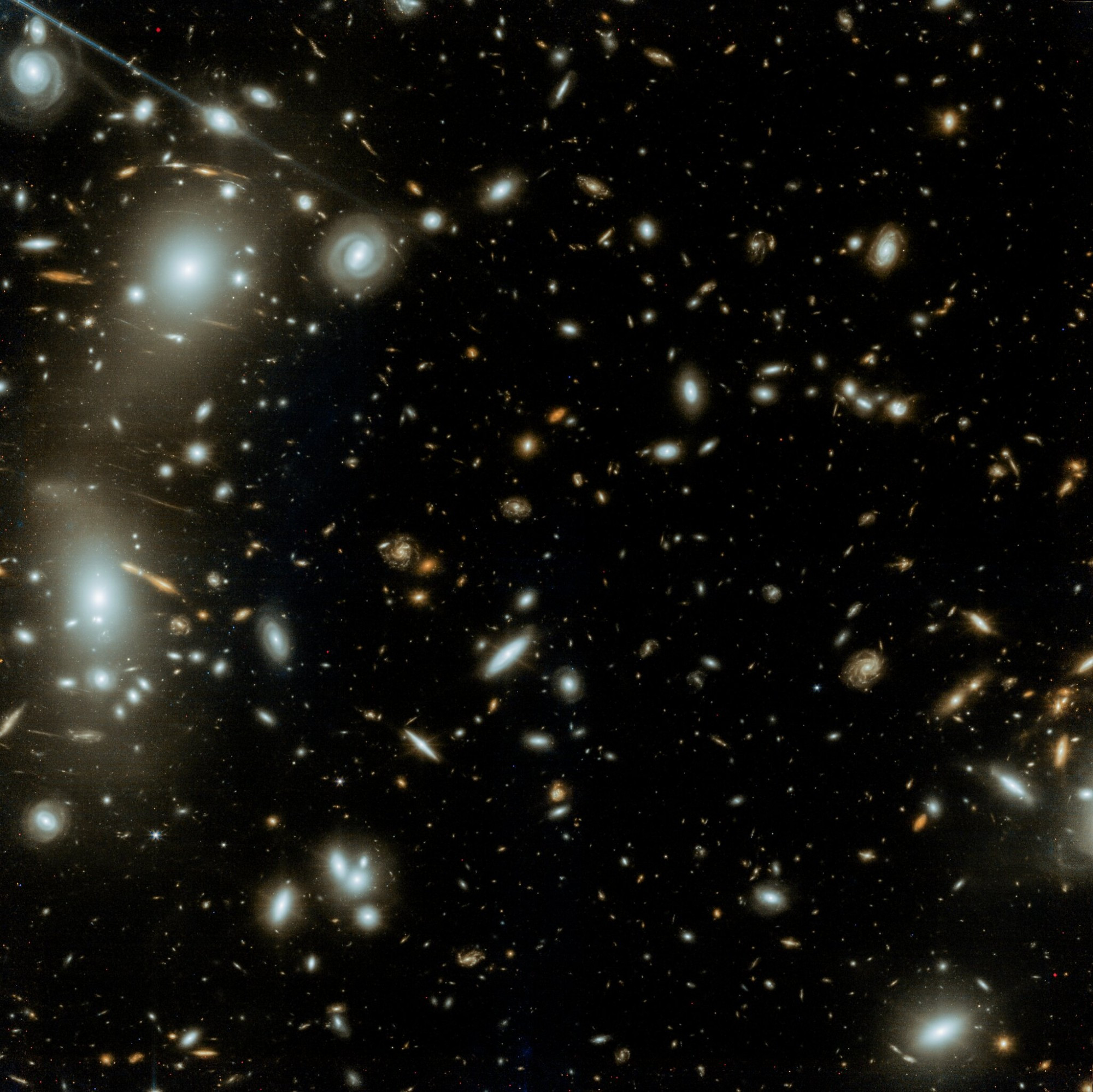 This near-infrared image, captured by the James Webb Space Telescope's NIRCam instrument, showcases the massive galaxy cluster Abell 2744, also known as Pandora's Cluster. Thousands of galaxies of various shapes, sizes, and colors are densely packed together, creating a breathtaking cosmic spectacle. The image reveals a complex web of intergalactic gas, with bright, elongated galaxies dominating the center. Fainter, more distant galaxies are scattered throughout the image, offering a glimpse into the early universe.