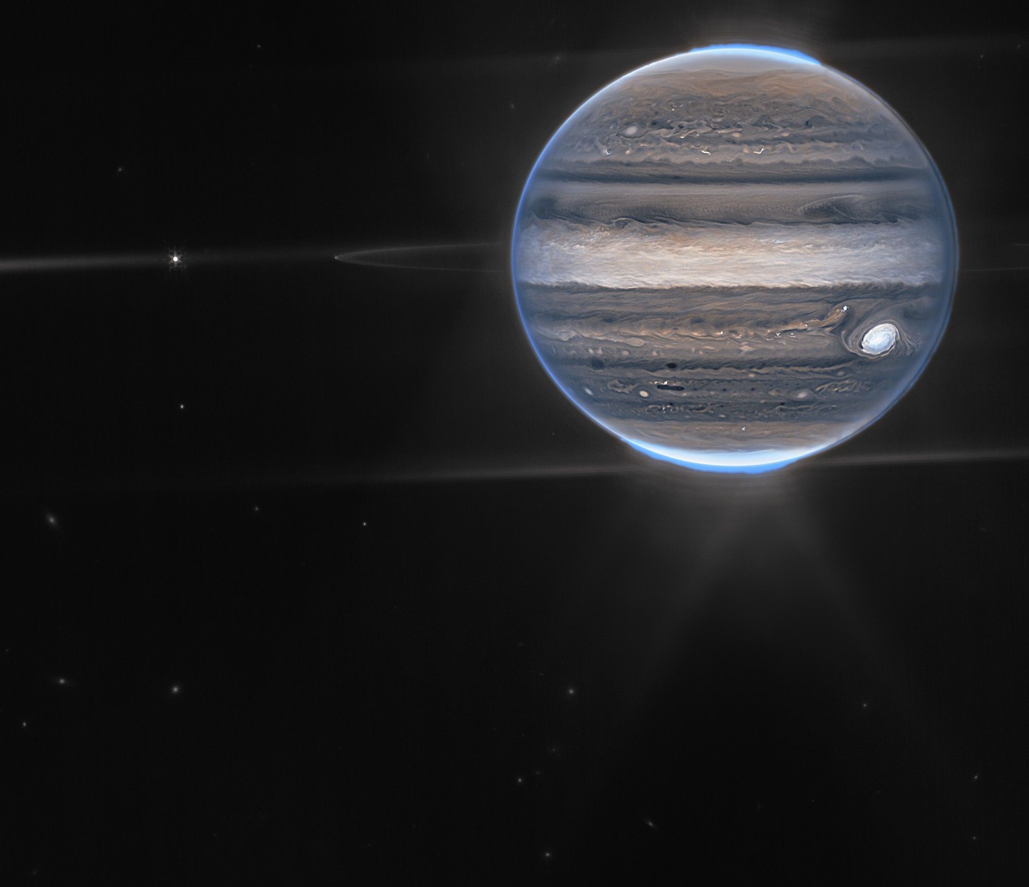 With giant storms, powerful winds, auroras, and extreme temperature and pressure conditions, Jupiter has a lot going on. Now, the NASA/ESA/CSA James Webb Space Telescope has captured new images of the planet. Webb’s Jupiter observations will give scientists even more clues to Jupiter’s inner life.

In this wide-field view, Webb sees Jupiter with its faint rings, which are a million times fainter than the planet, and two tiny moons called Amalthea and Adrastea. The fuzzy spots in the lower background are likely galaxies “photobombing” this Jovian view.  

This is a composite image from Webb’s NIRCam instrument (two filters) and was acquired on 27 July 2022.

Credit:
NASA, ESA, Jupiter ERS Team; image processing by Ricardo Hueso (UPV/EHU) and Judy Schmidt