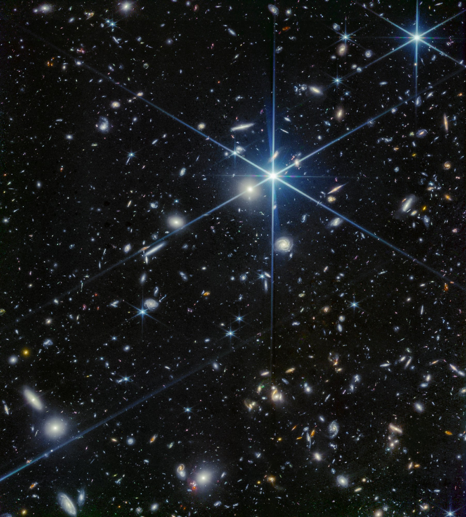 A deep-field image taken by the NIRCam instrument on the James Webb Space Telescope, revealing countless galaxies in the Grus constellation. The image is filled with bright stars and distant galaxies, showcasing the vastness and complexity of the universe.