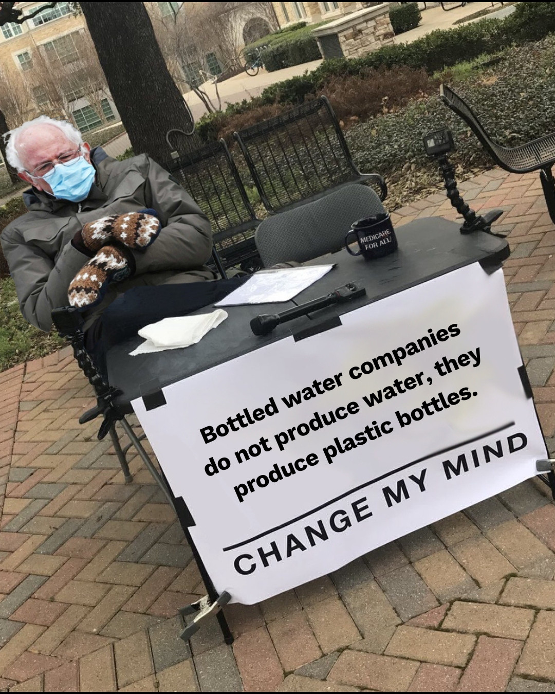 Bernie Saunders with mittens on sat at change my mind meme table with text " Bottled water companies do not produce water, they produce plastic bottles. Change my mind" 