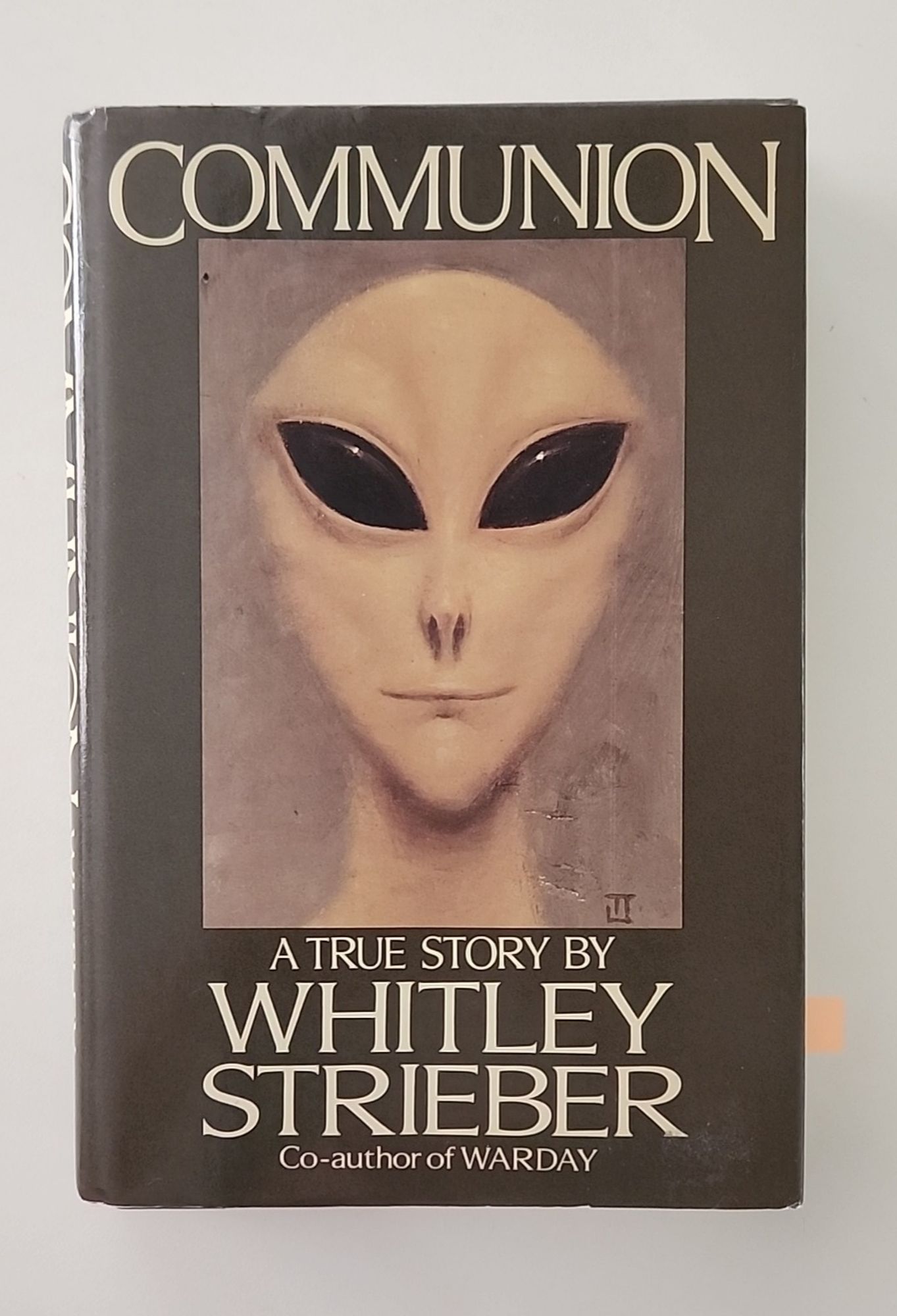 The cover of the iconic book Communion by Whitley Strieber, featuring the face of whatbis now known as a "Grey" with its oversized bald head, large slanted almond eyes, undersized nose and slit of a mouth.