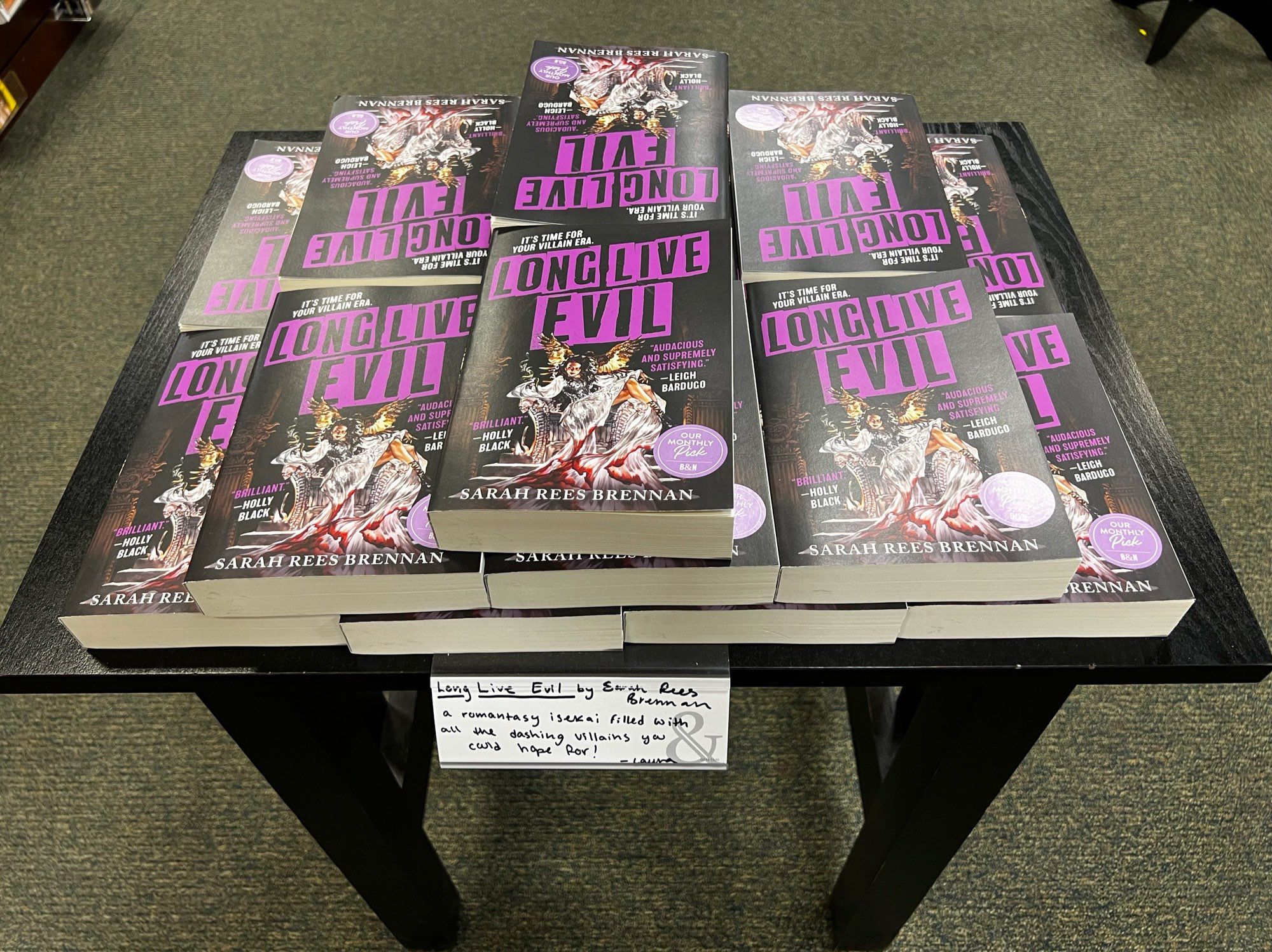 A table topped with copies of Long Live Evil by Sarah Rees Brennan.