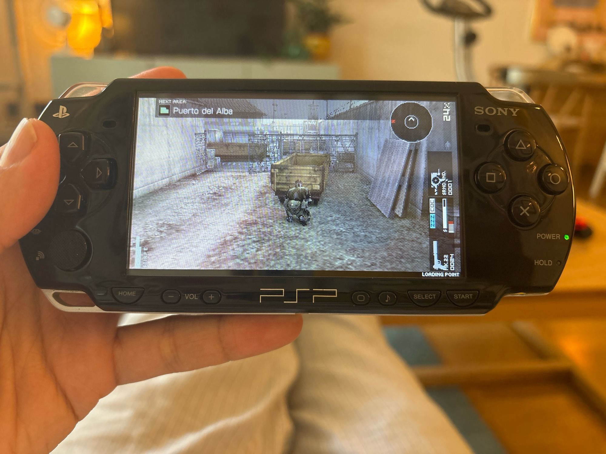 Eric holding a PSP which is playing the title “Metal Gear Solid: Peace Walker”. He could have played the ported version on consoles, like a sane person, but Eric is down the rabbit hole now. Goodbye forever, Eric.