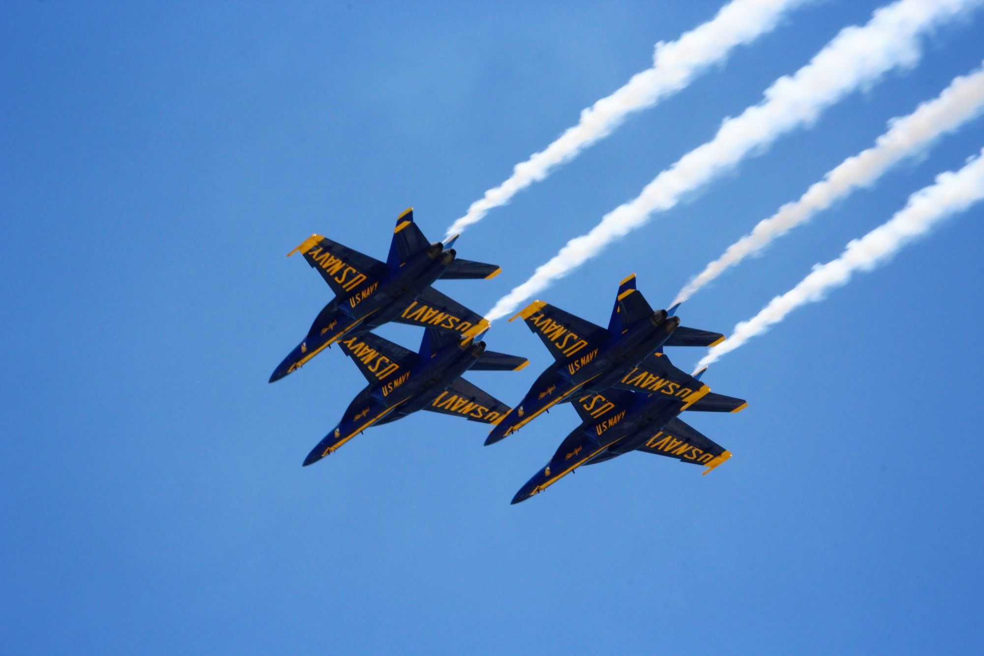 Four of the Blue Angels flying in formation